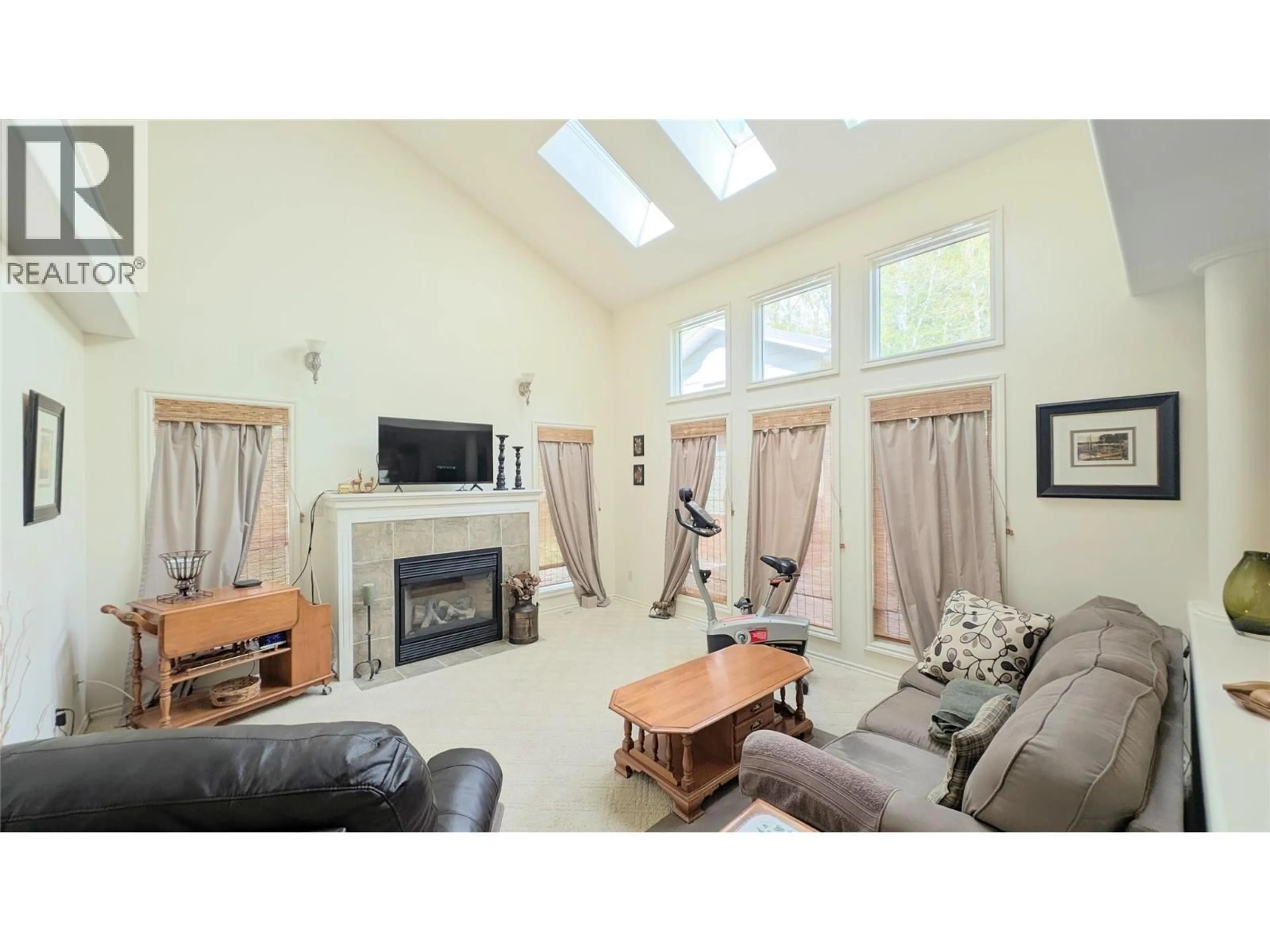 Living room with furniture, wood/laminate floor for 4893 FAIRMONT CREEK ROAD, Fairmont Hot Springs British Columbia V0B1L1