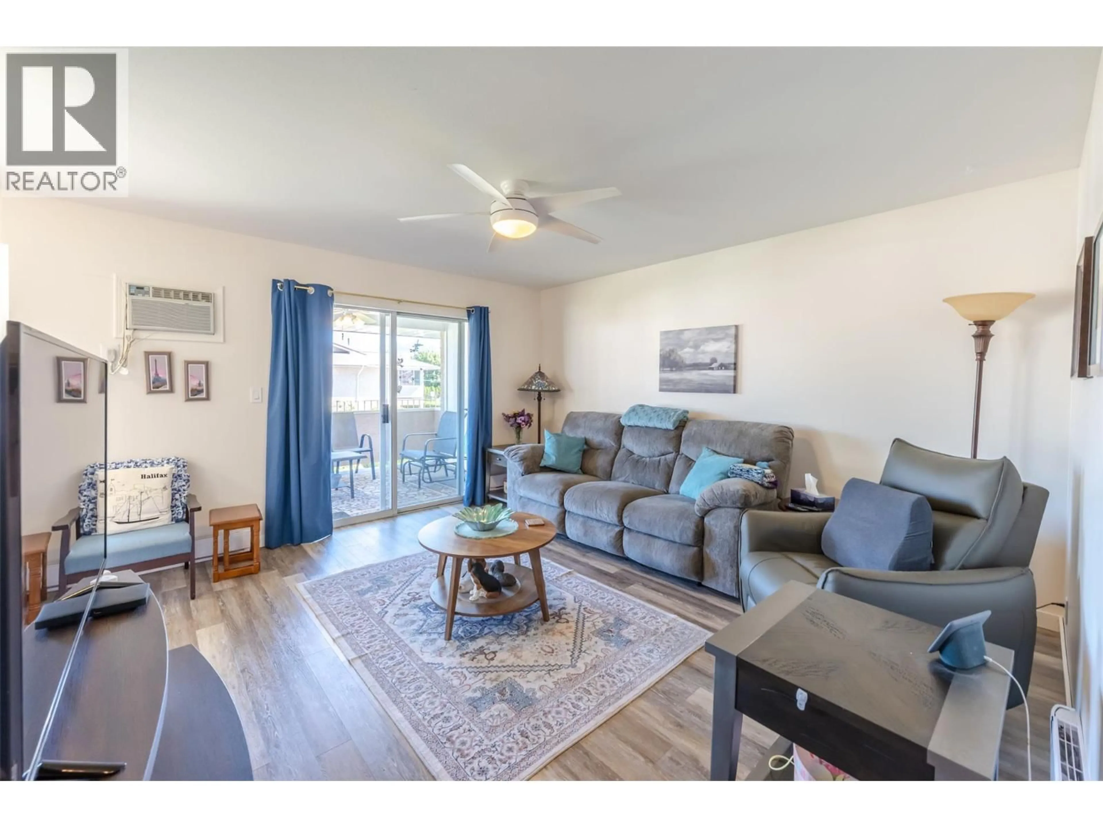 Living room with furniture, wood/laminate floor for 4 - 14008 VICTORIA ROAD NORTH, Summerland British Columbia V0H1Z5