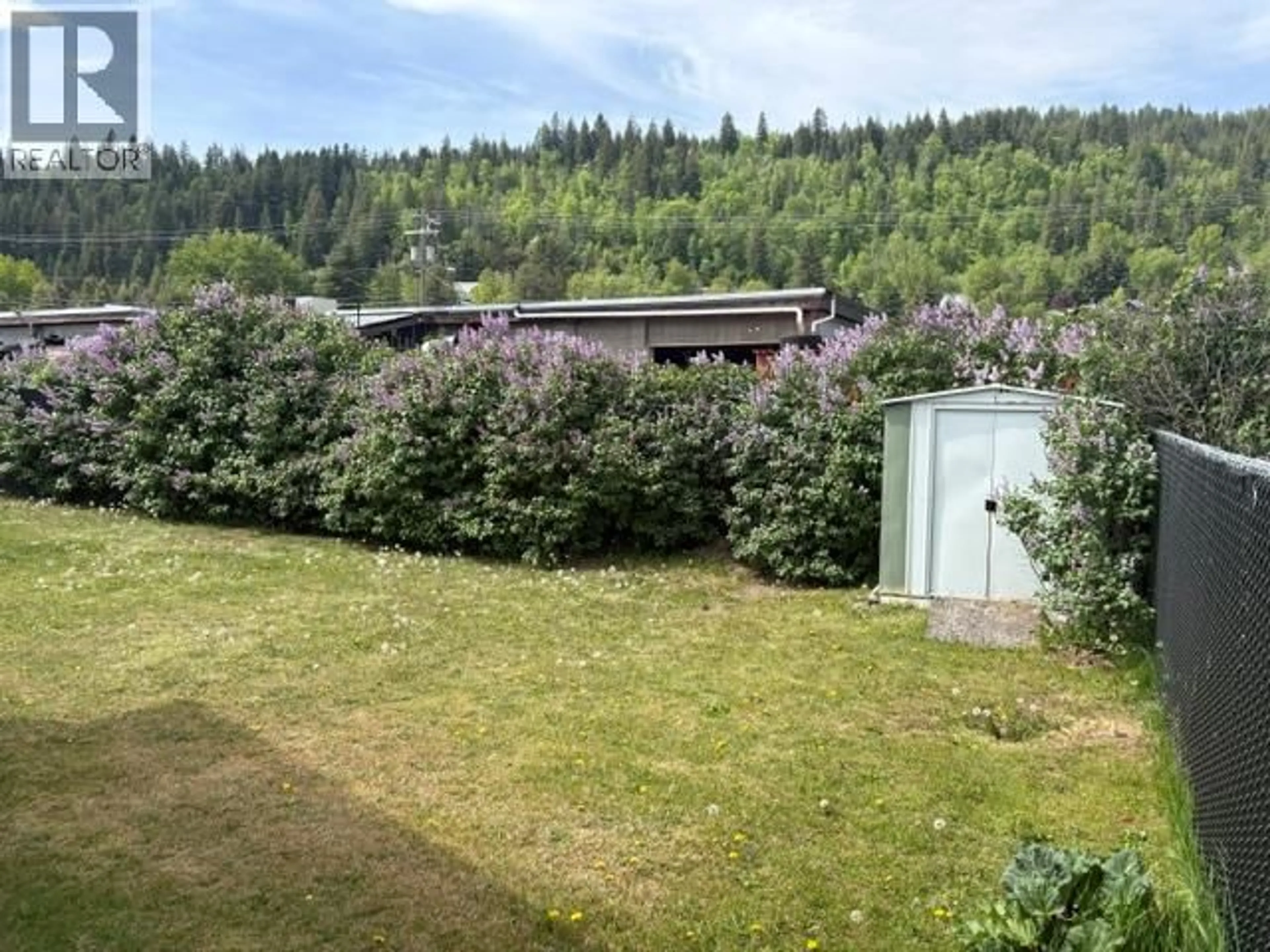 A pic from outside/outdoor area/front of a property/back of a property/a pic from drone, forest/trees view for 1 - 1509 HUNTERS PLACE, Castlegar British Columbia V1N2L1