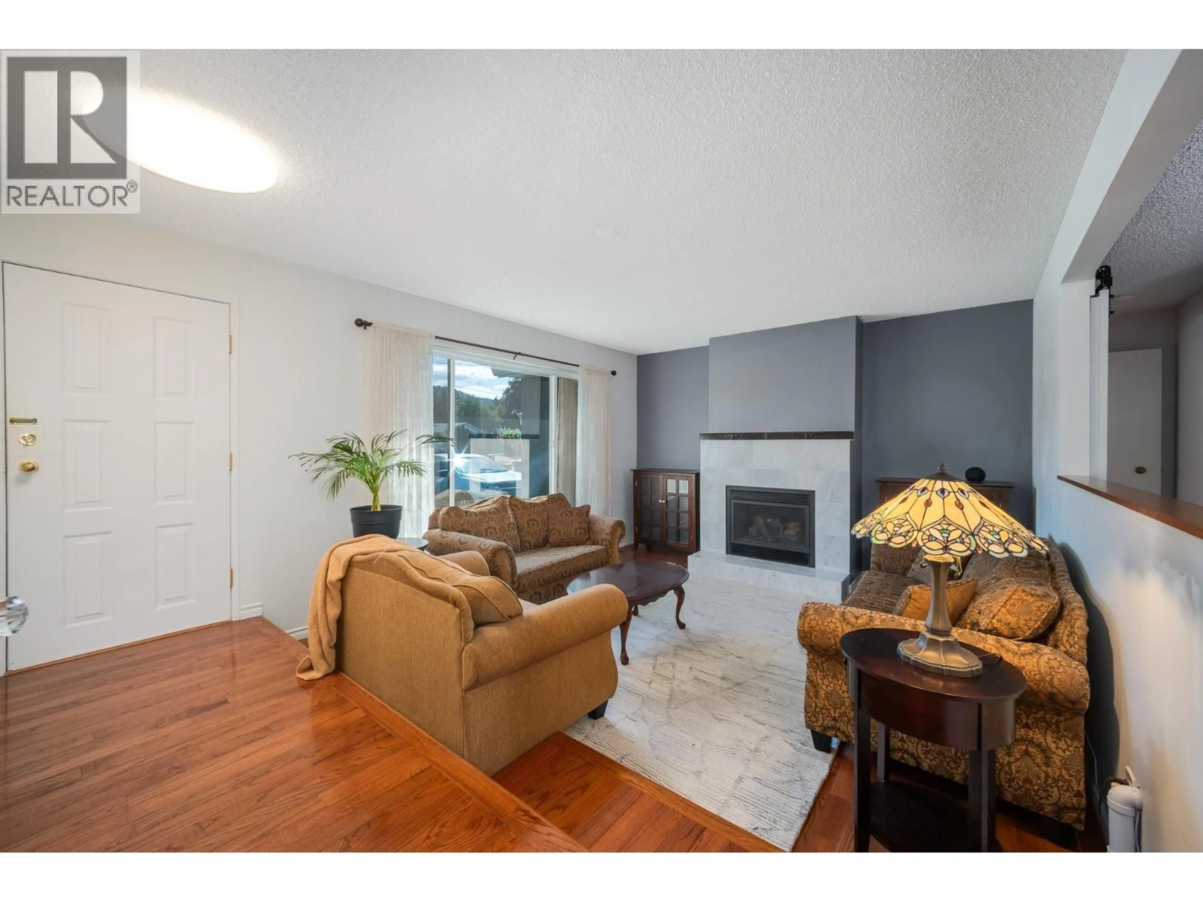 Living room with furniture, wood/laminate floor for 350 PERTH ROAD, Kelowna British Columbia V1X3R4