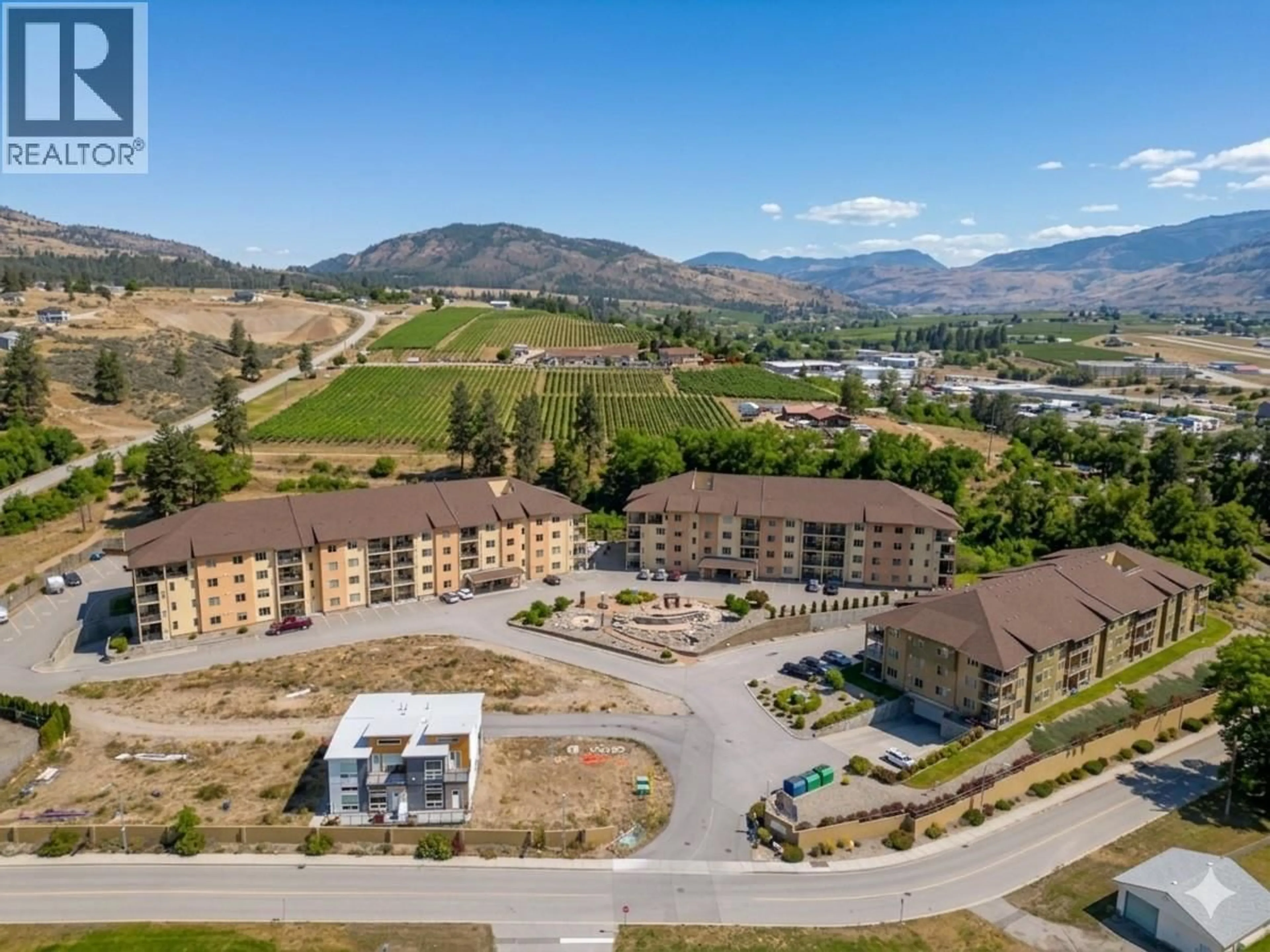 A pic from outside/outdoor area/front of a property/back of a property/a pic from drone, mountain view for 107B - 921 SPILLWAY ROAD, Oliver British Columbia V0H1T8