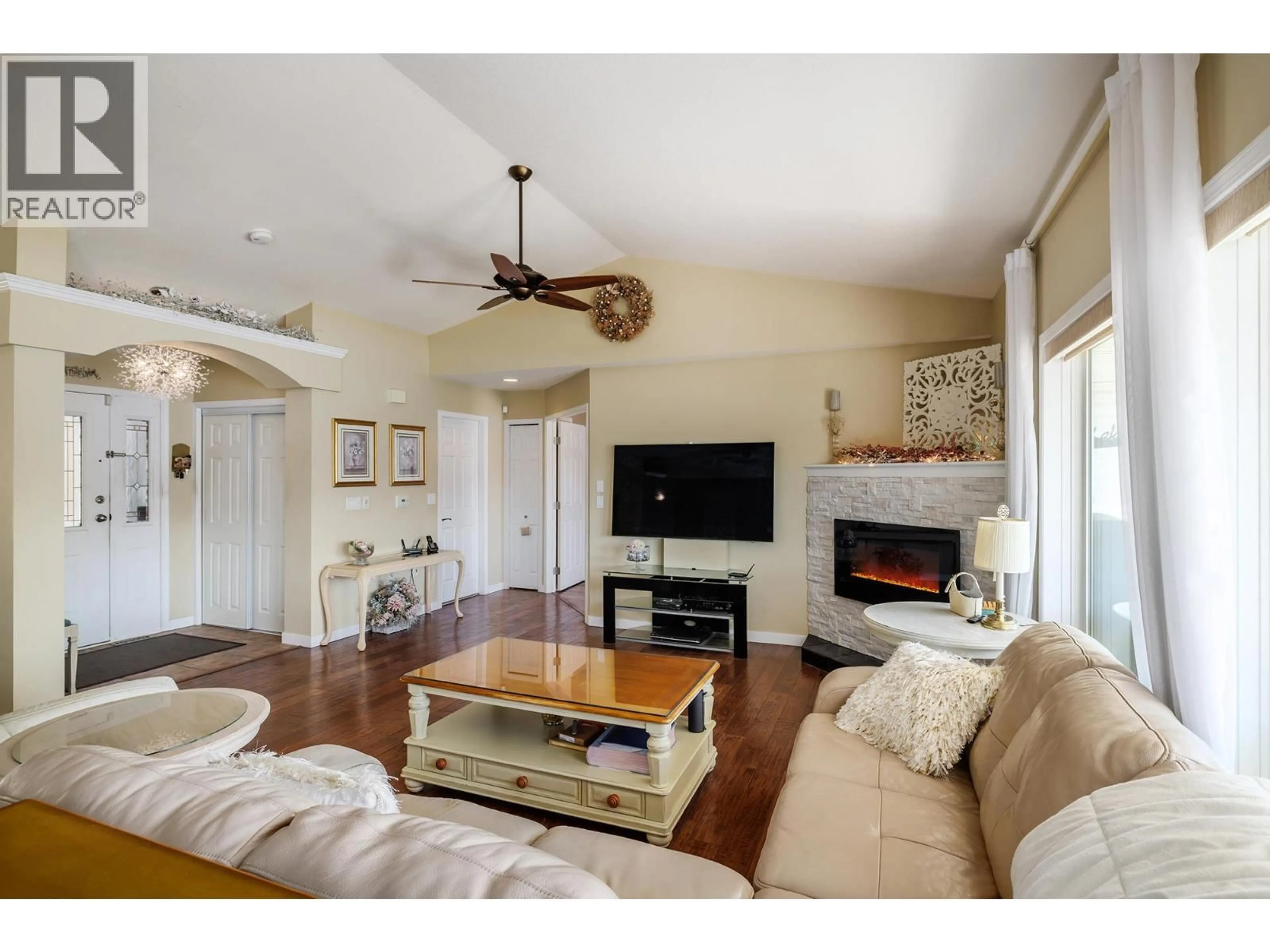 Living room with furniture, wood/laminate floor for 5273 SUTHERLAND ROAD, Peachland British Columbia V0H1X2