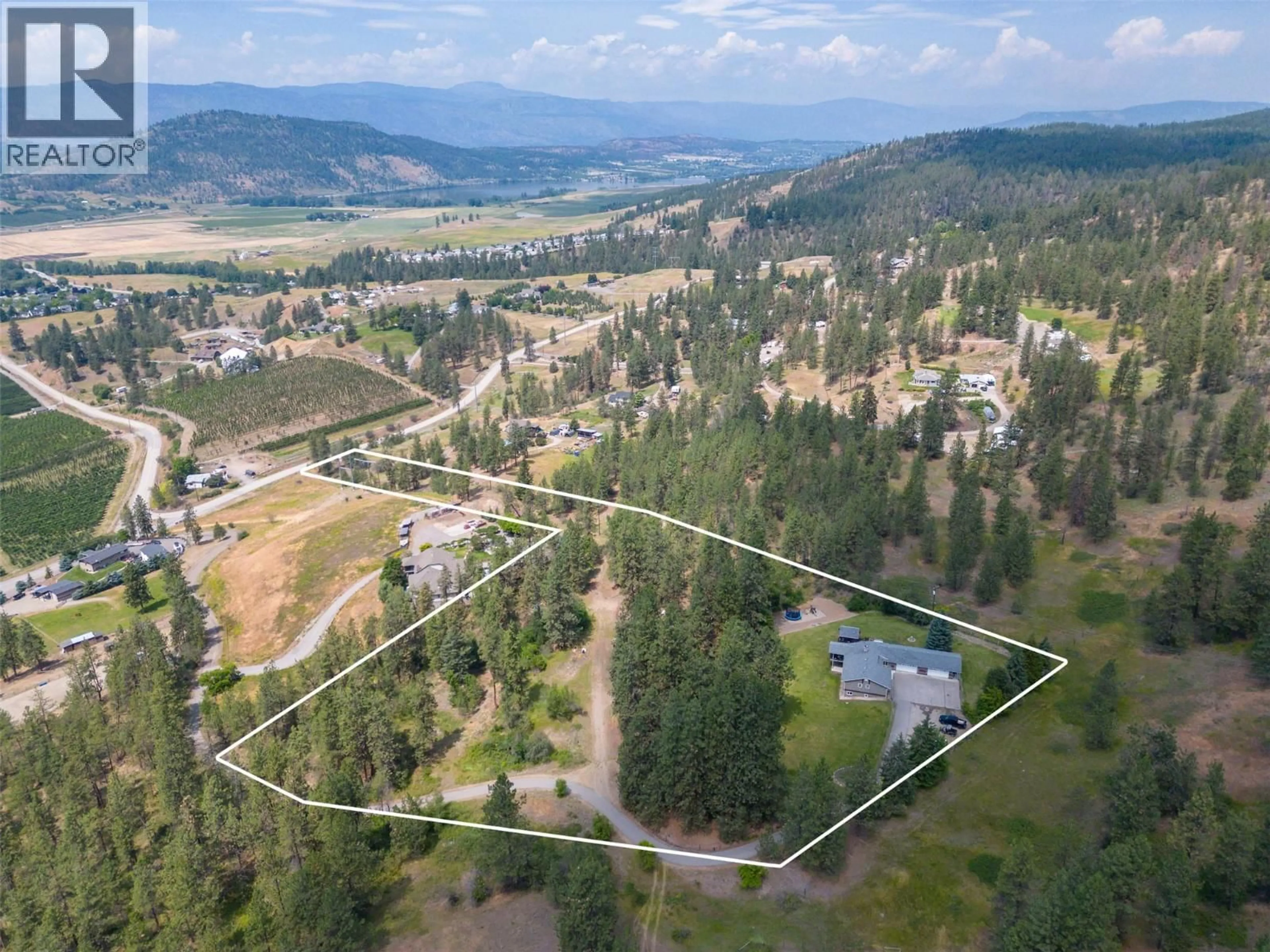 A pic from outside/outdoor area/front of a property/back of a property/a pic from drone, mountain view for 6051 POSTILL LAKE ROAD, Kelowna British Columbia V1X7V3