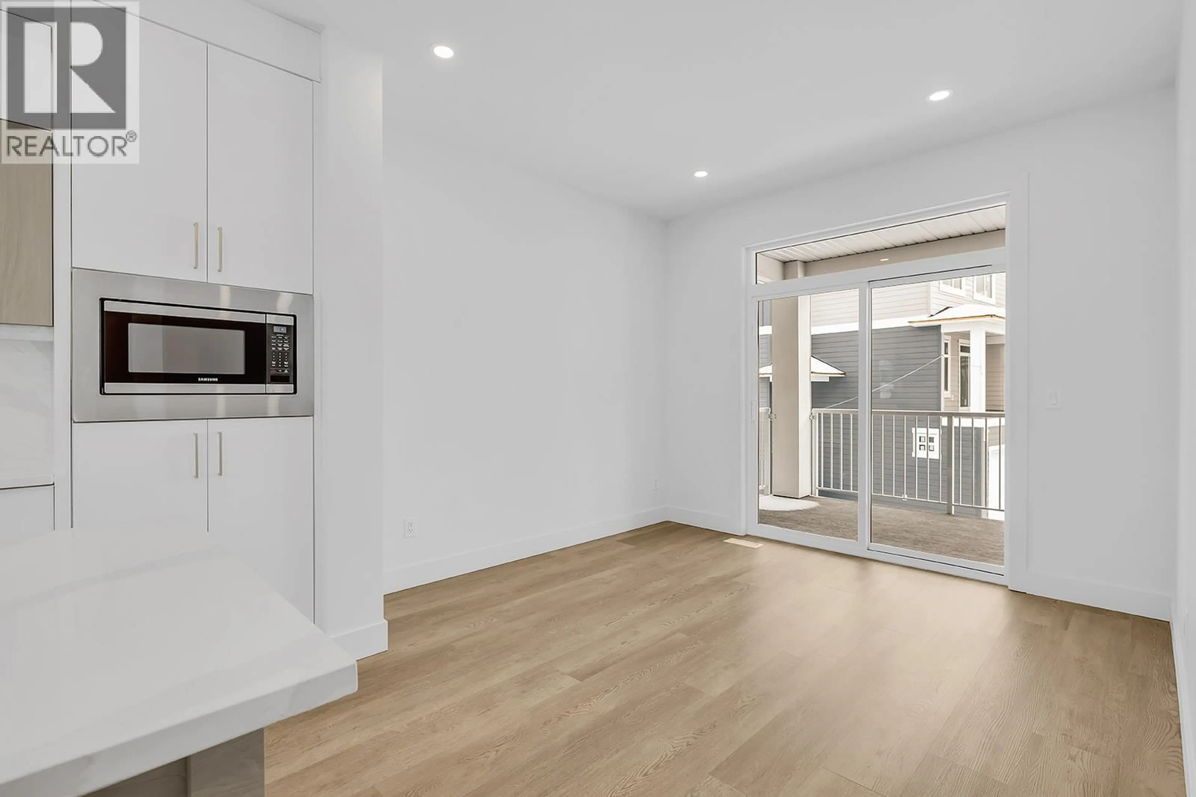 Open concept kitchen, wood/laminate floor for 103 - 5300 MAIN STREET, Kelowna British Columbia V1W0C1