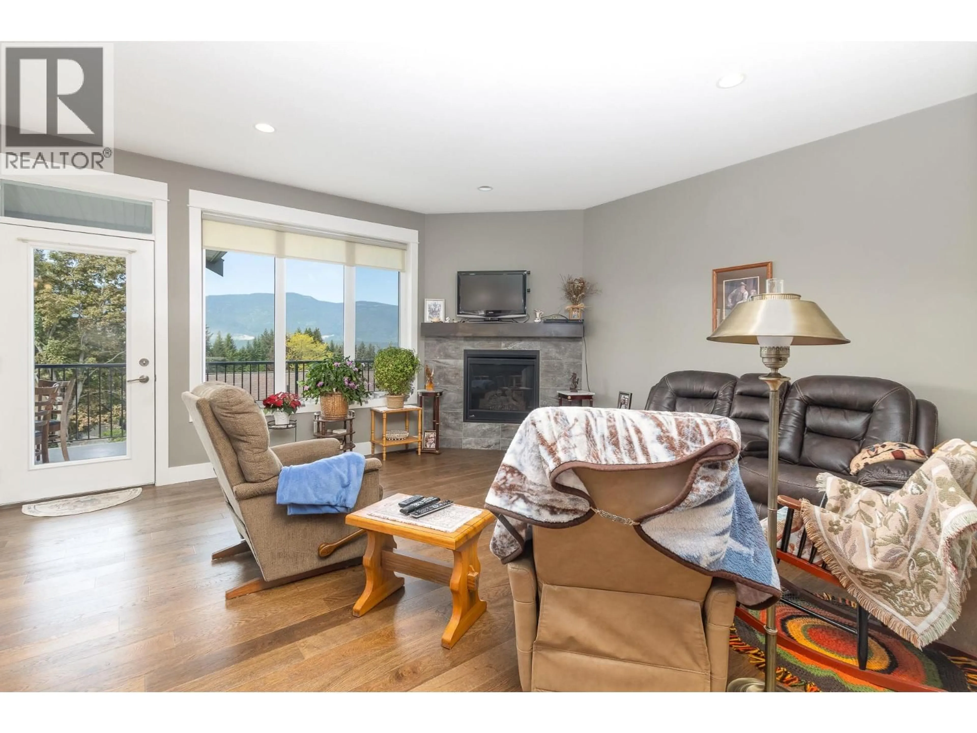 Living room with furniture, wood/laminate floor for 221 24 STREET NORTHEAST, Salmon Arm British Columbia V1E0C2