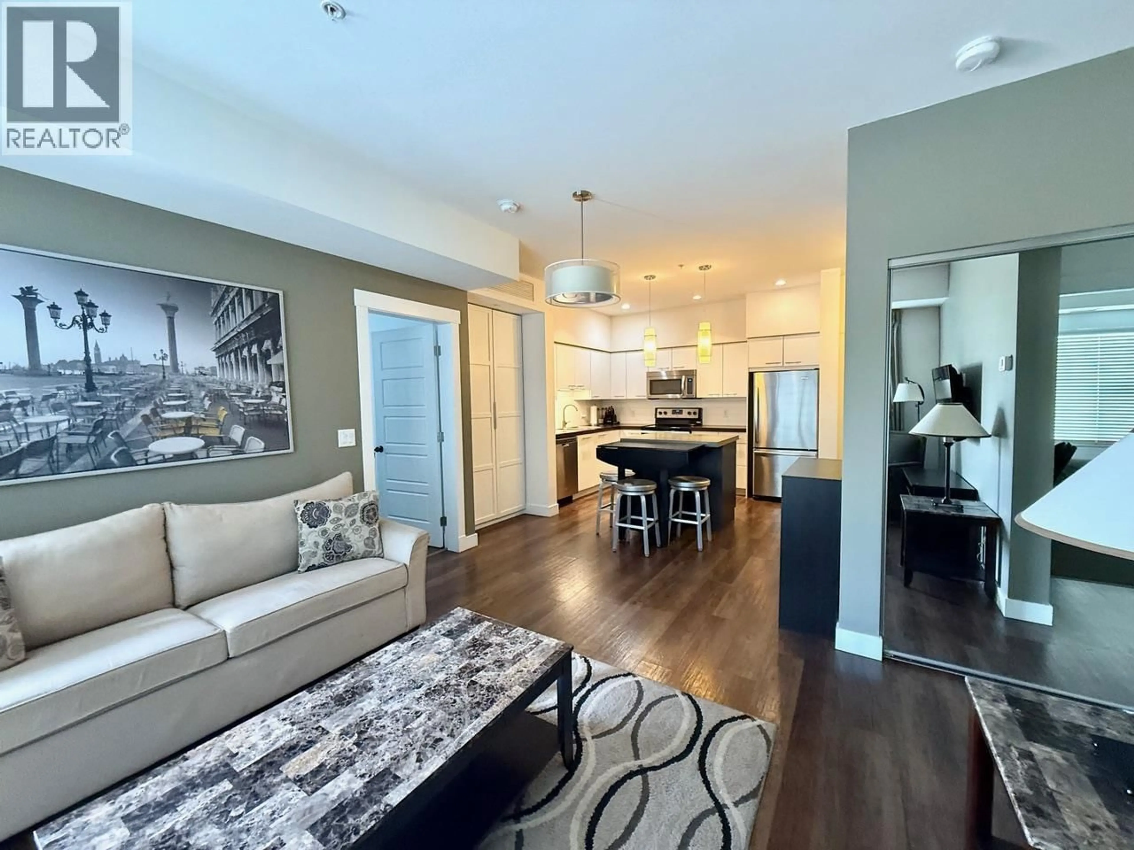 Living room with furniture, wood/laminate floor for 216 - 975 ACADEMY WAY, Kelowna British Columbia V1V3C8