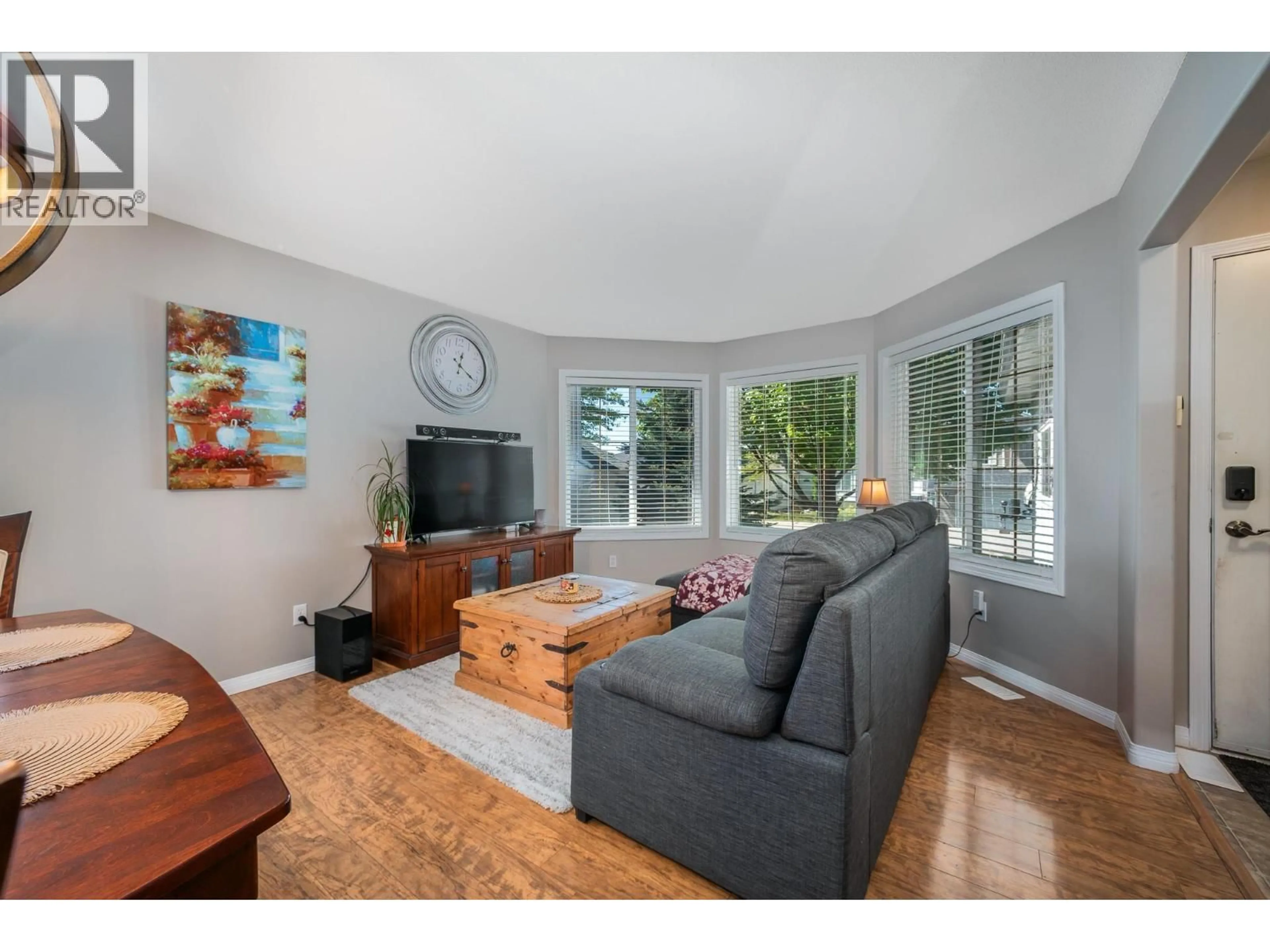 Living room with furniture, wood/laminate floor for 8 - 4450 POSTILL DRIVE, Kelowna British Columbia V1X7T9