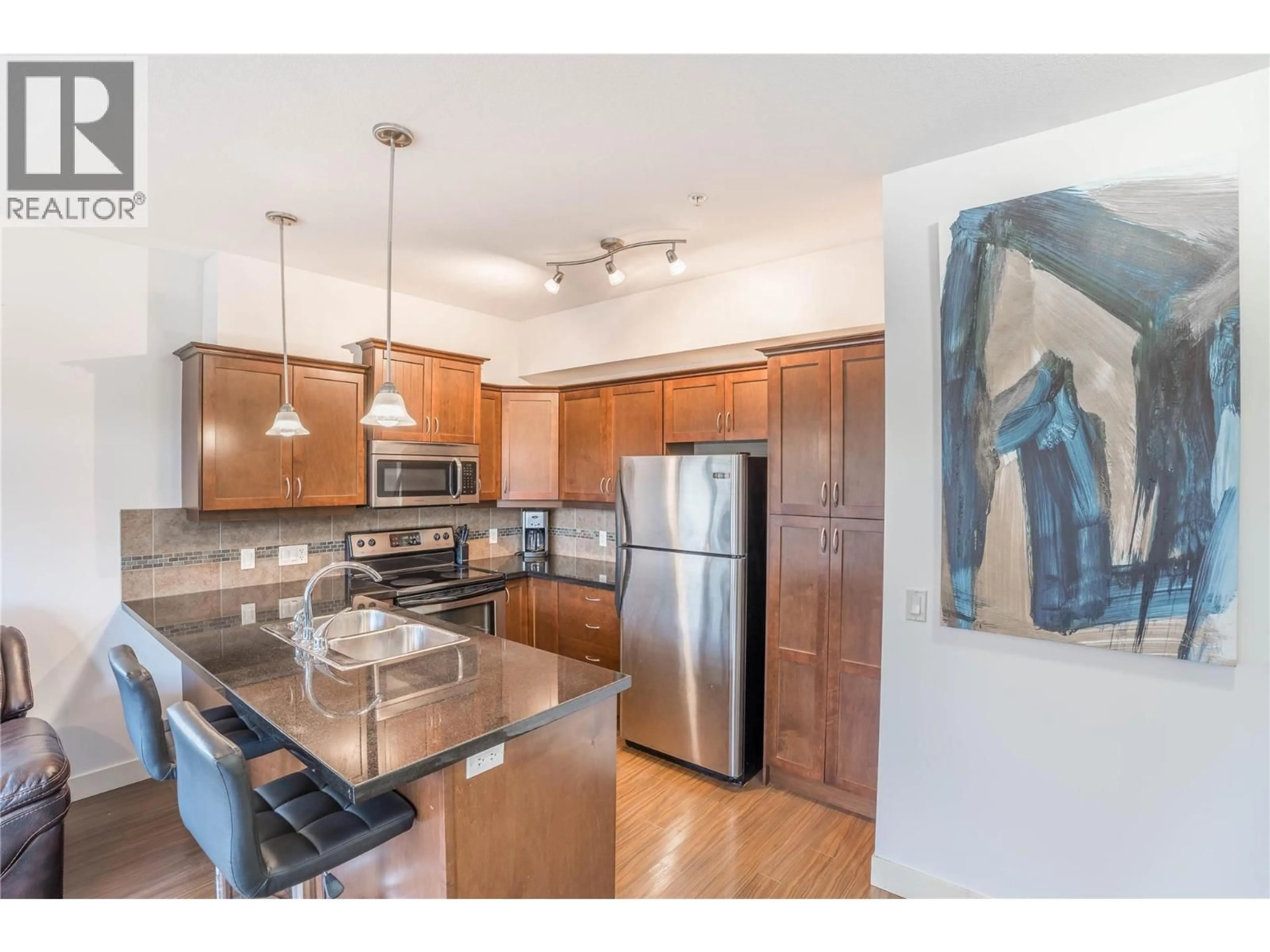 Open concept kitchen, wood/laminate floor for 213 - 3533 CARRINGTON ROAD, West Kelowna British Columbia V4T2Z9