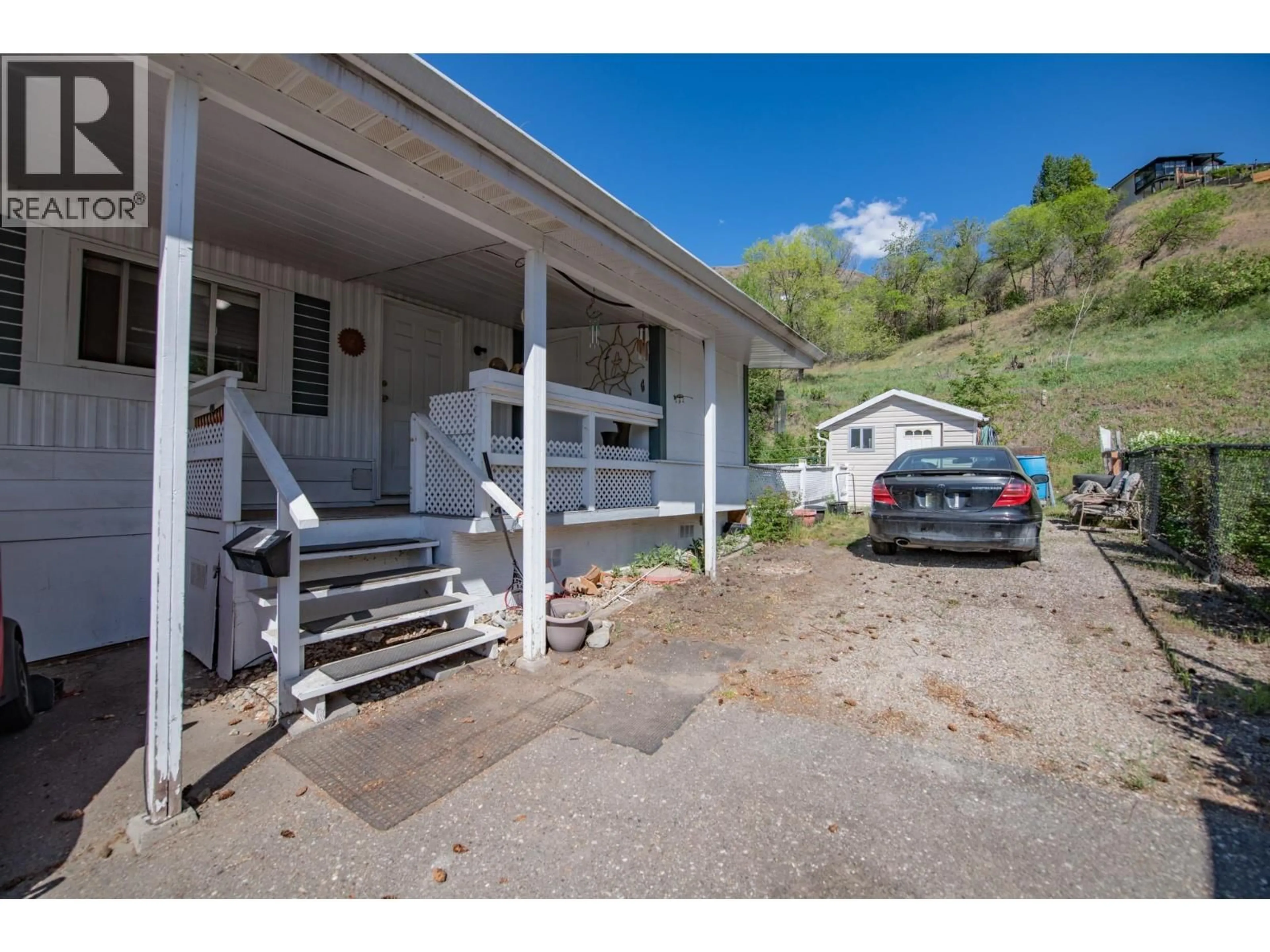 A pic from outside/outdoor area/front of a property/back of a property/a pic from drone, street for 15401 KALAMALKA ROAD, Coldstream British Columbia V1B1Z3