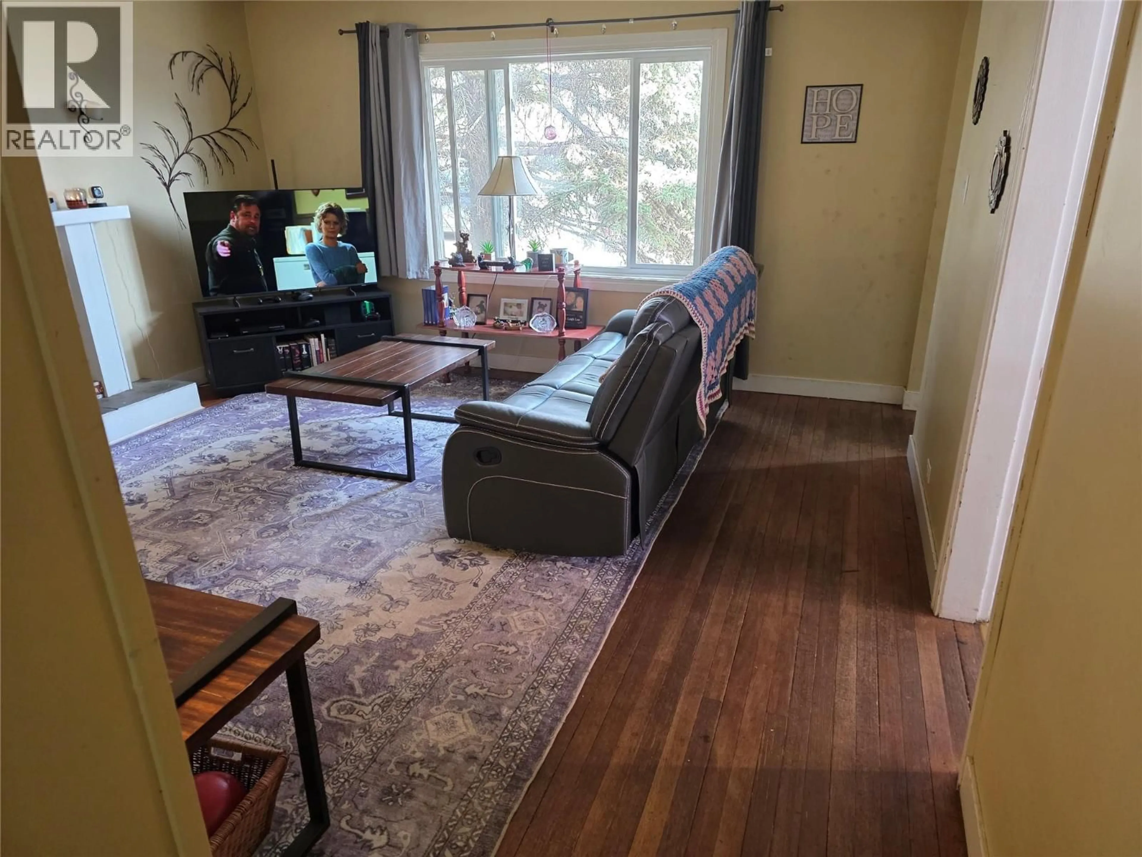 Living room with furniture, wood/laminate floor for 1225 104 AVENUE, Dawson Creek British Columbia V1G2J4
