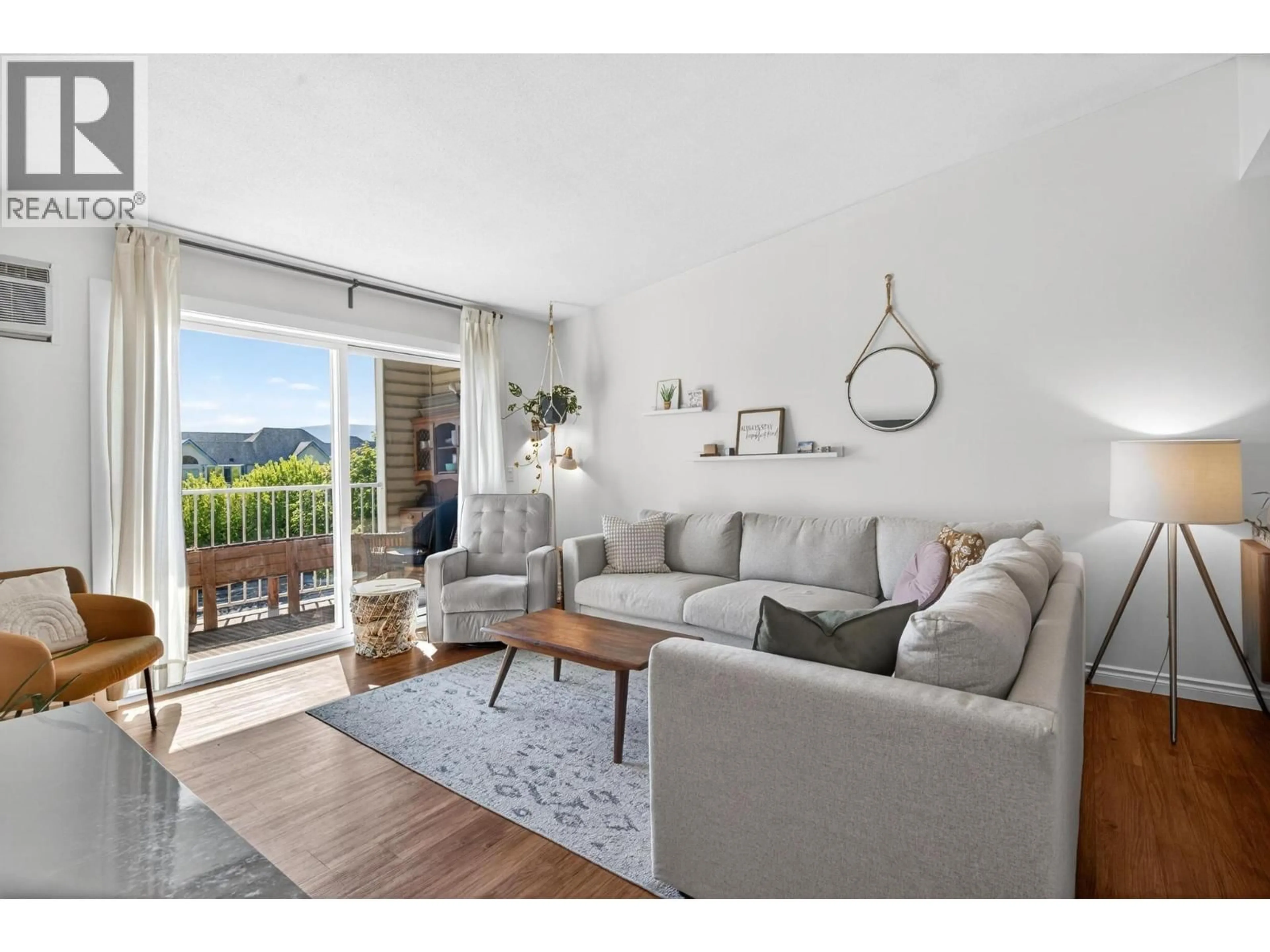 Living room with furniture, wood/laminate floor for 420 - 3160 CASORSO ROAD, Kelowna British Columbia V1W3L7