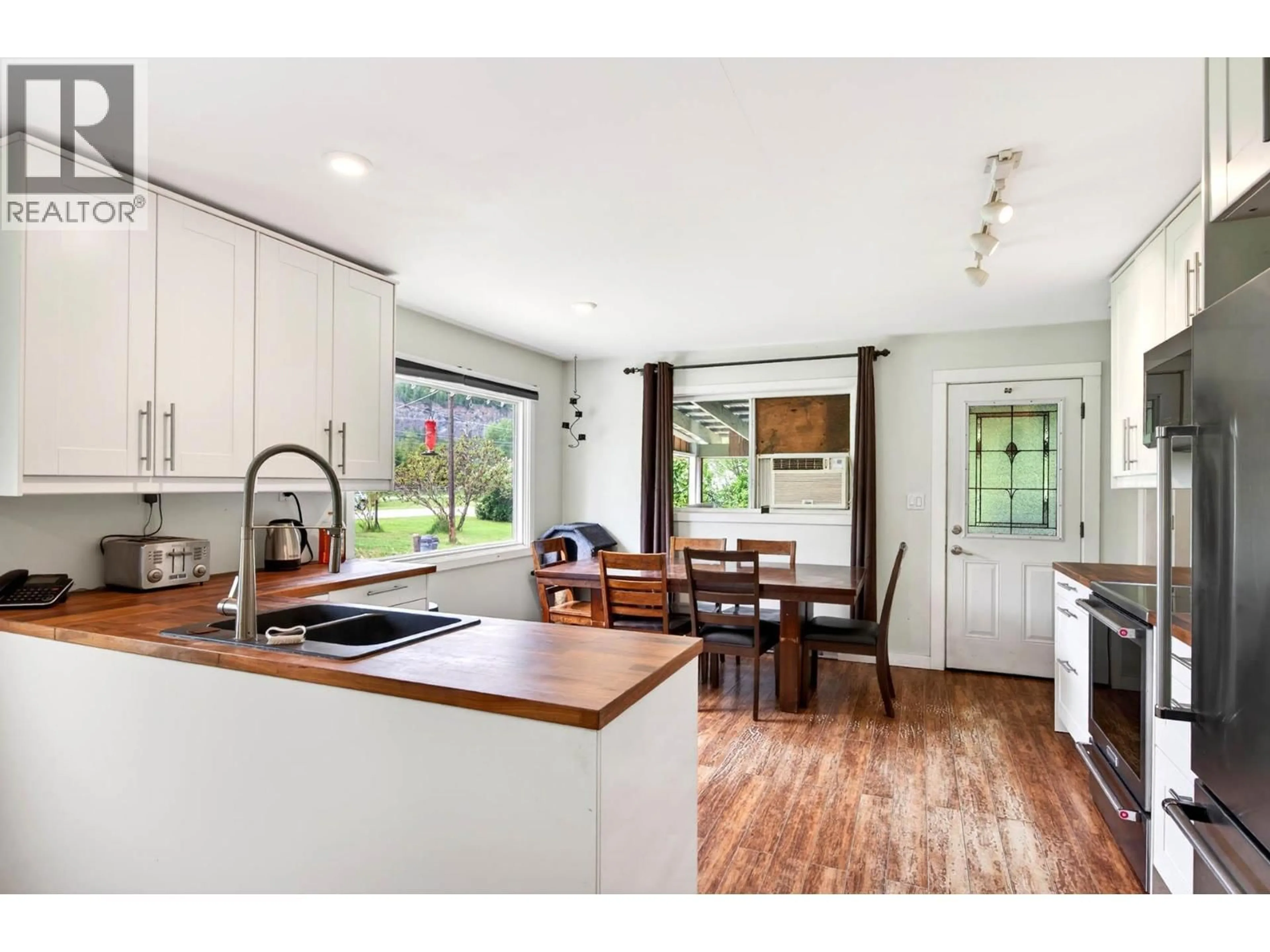 Open concept kitchen, wood/laminate floor for 1256 HERN ROAD, Clearwater British Columbia V0E1N2