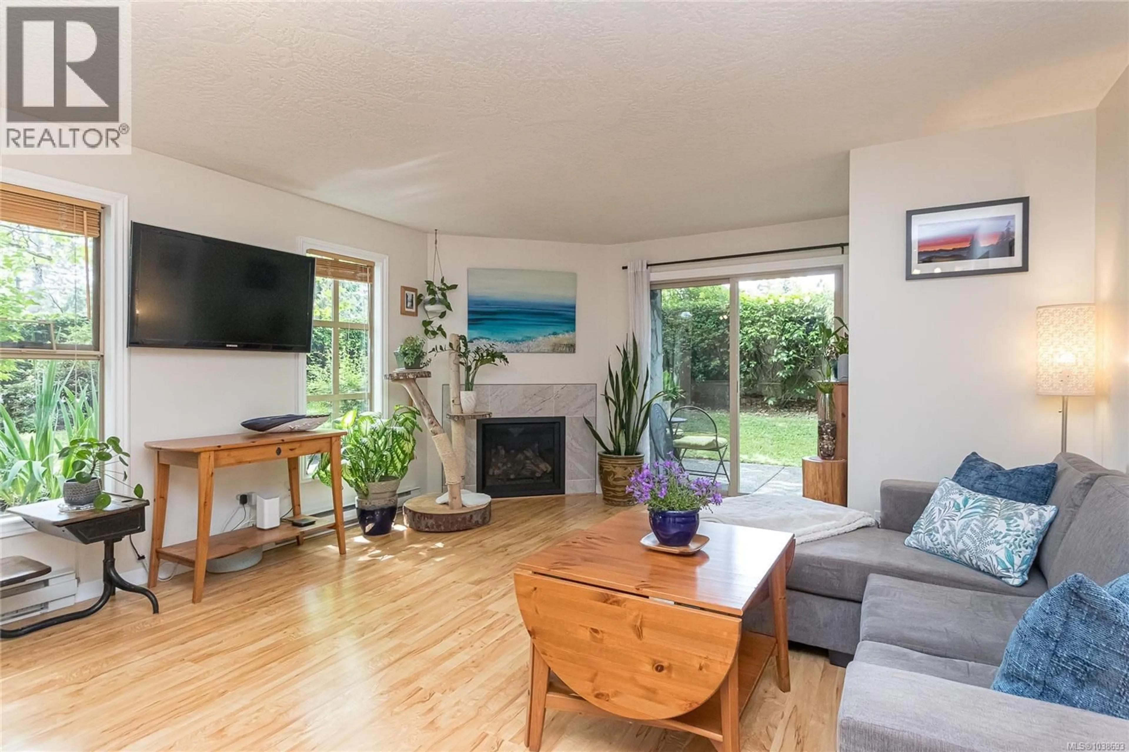 Living room with furniture, wood/laminate floor for 102 - 108 GORGE ROAD WEST, Saanich British Columbia V9A1M2