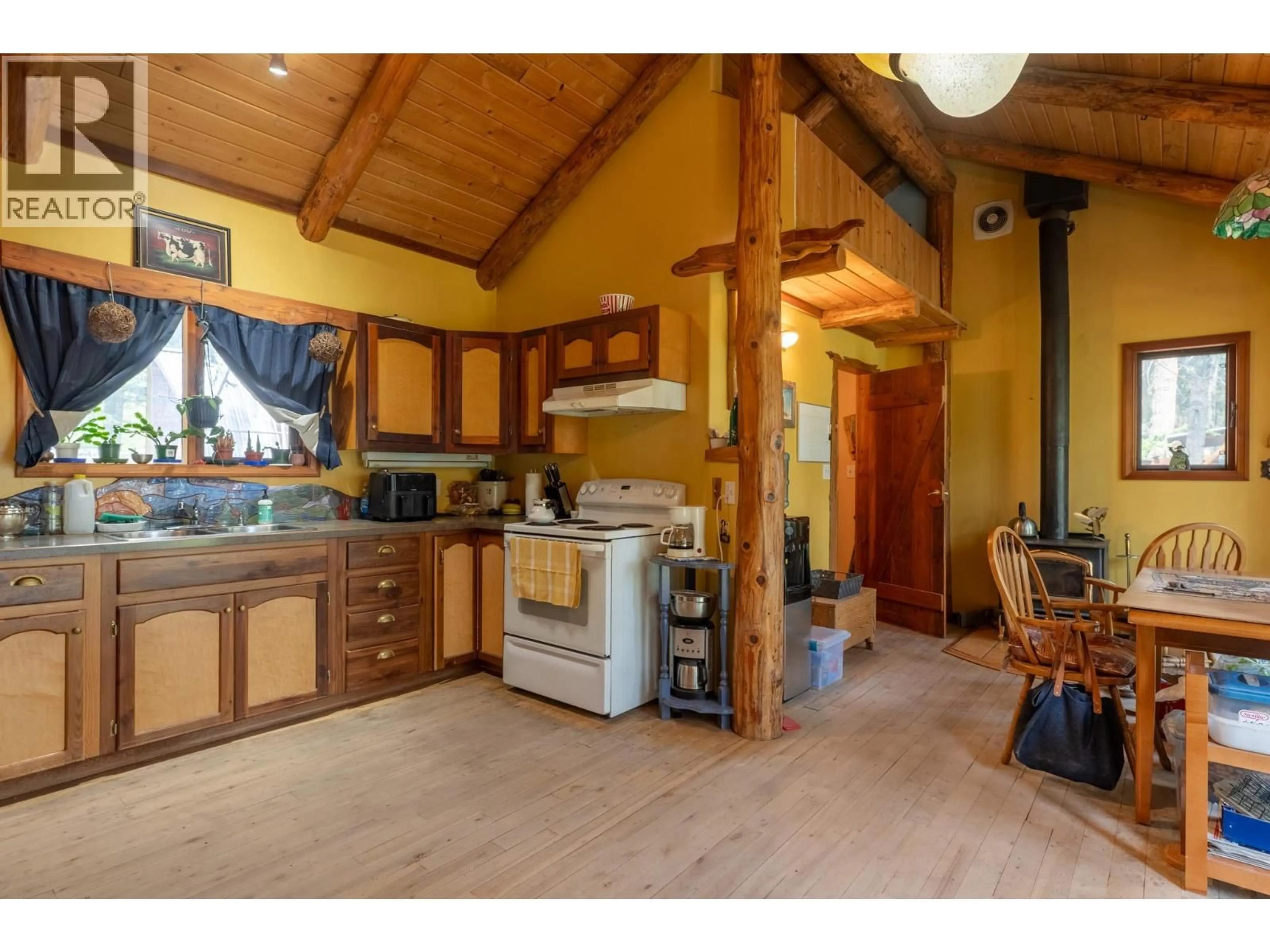 Open concept kitchen, wood/laminate floor for 9635 KEITHLEY ROAD, Vernon British Columbia V1H2E6