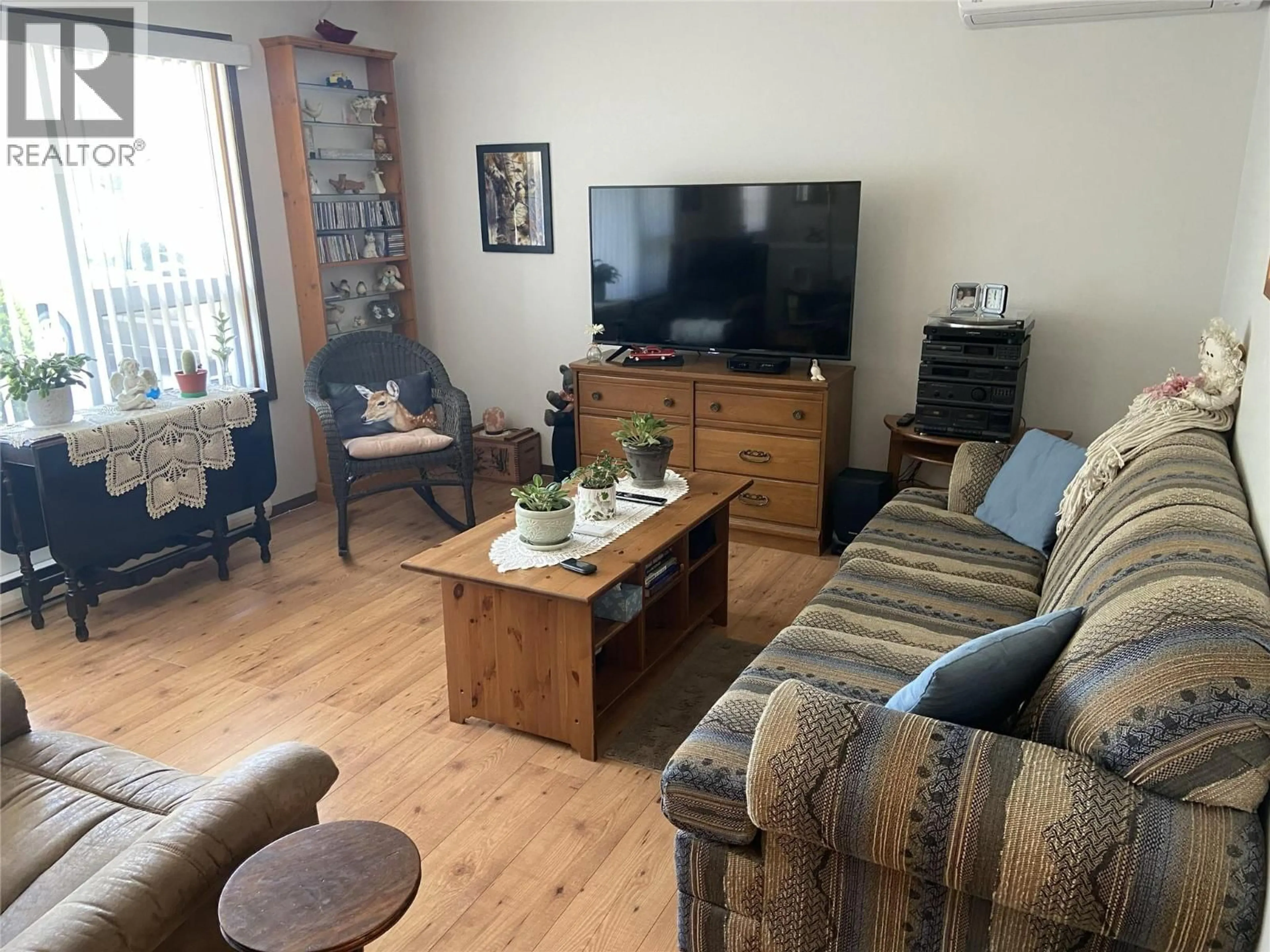 Living room with furniture, wood/laminate floor for 7372 DONALDSON DRIVE, Grand Forks British Columbia V0H1H0