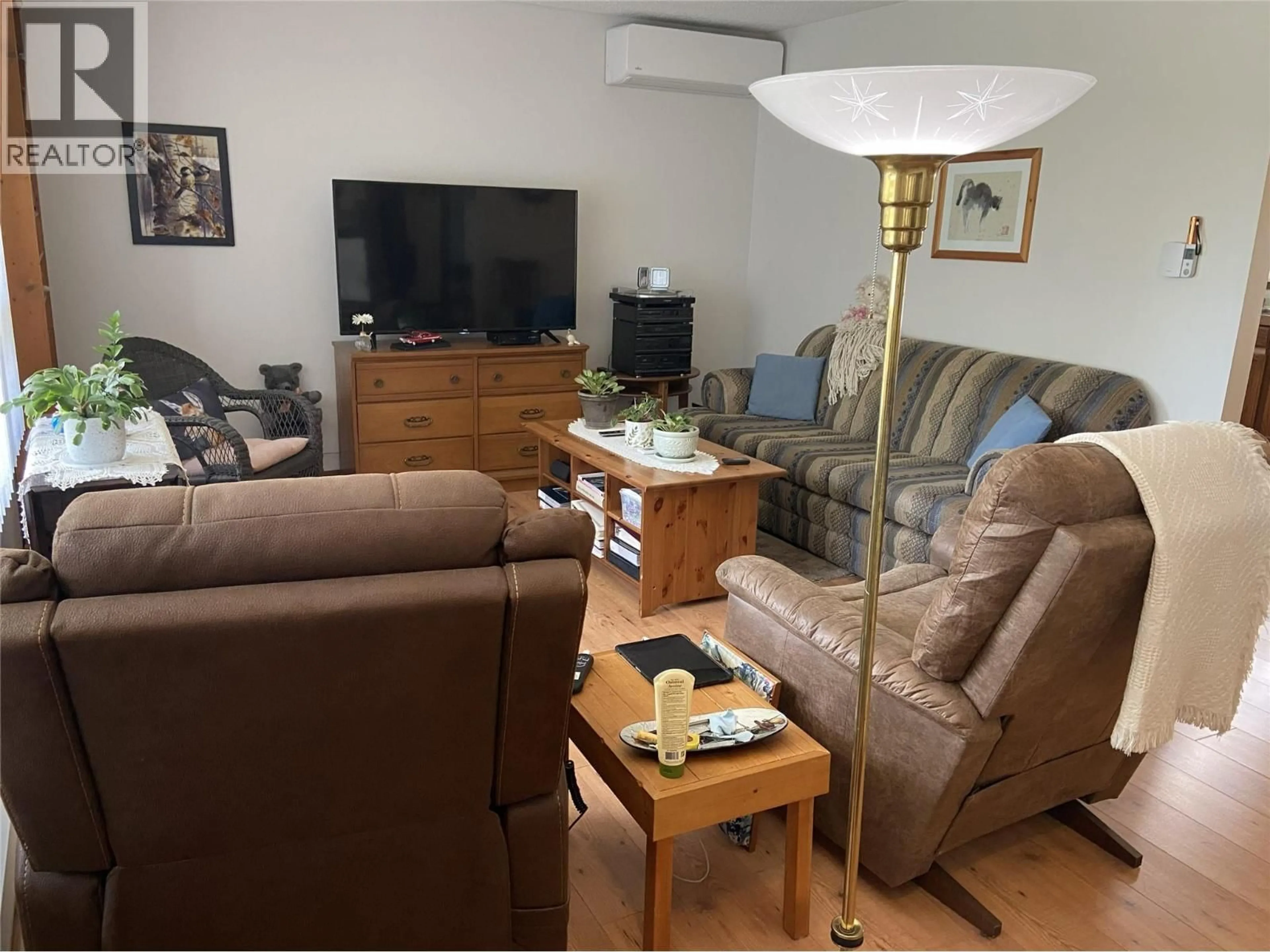Living room with furniture, wood/laminate floor for 7372 DONALDSON DRIVE, Grand Forks British Columbia V0H1H0