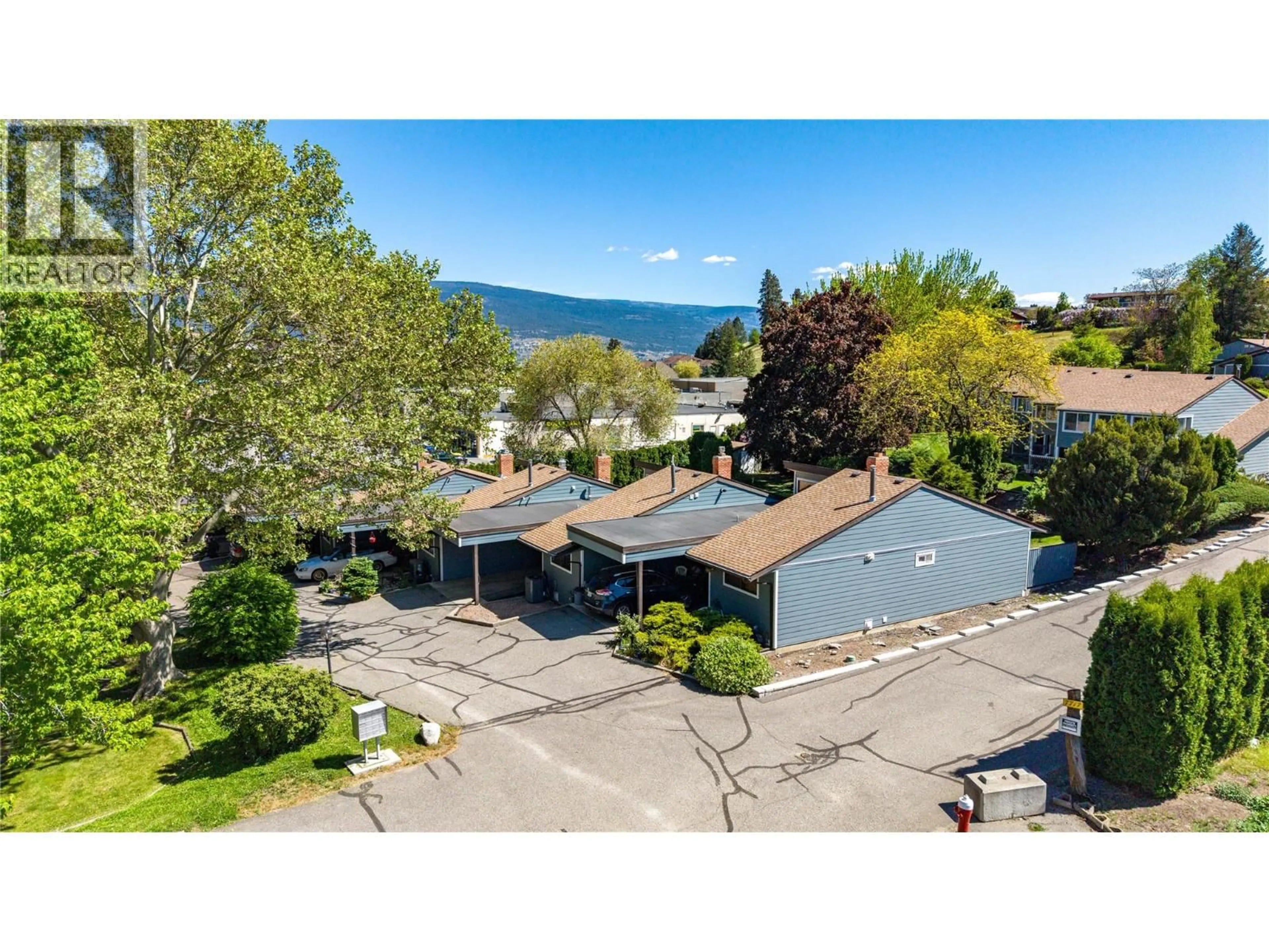 A pic from outside/outdoor area/front of a property/back of a property/a pic from drone, water/lake/river/ocean view for 104 - 7717 PRAIRIE VALLEY ROAD, Summerland British Columbia V0H1Z4