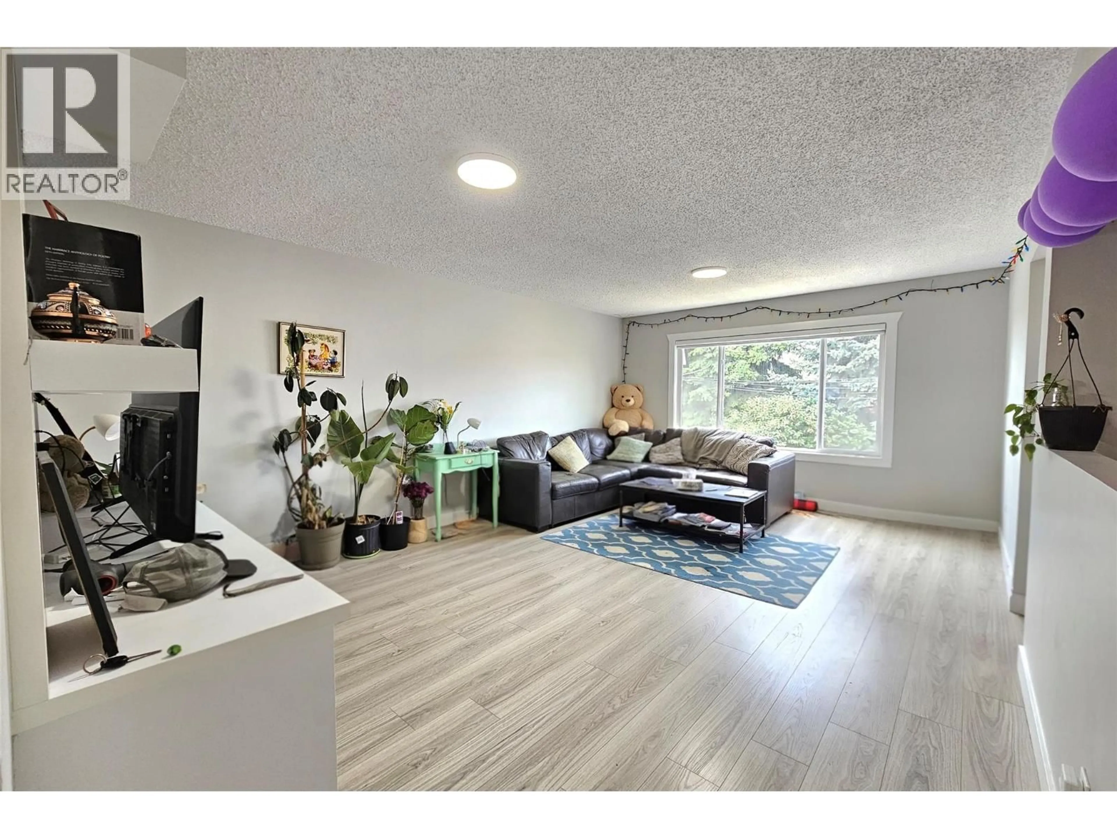 Living room with furniture, wood/laminate floor for 1635-1637 FINDLAY ROAD, Kelowna British Columbia V1X5B6