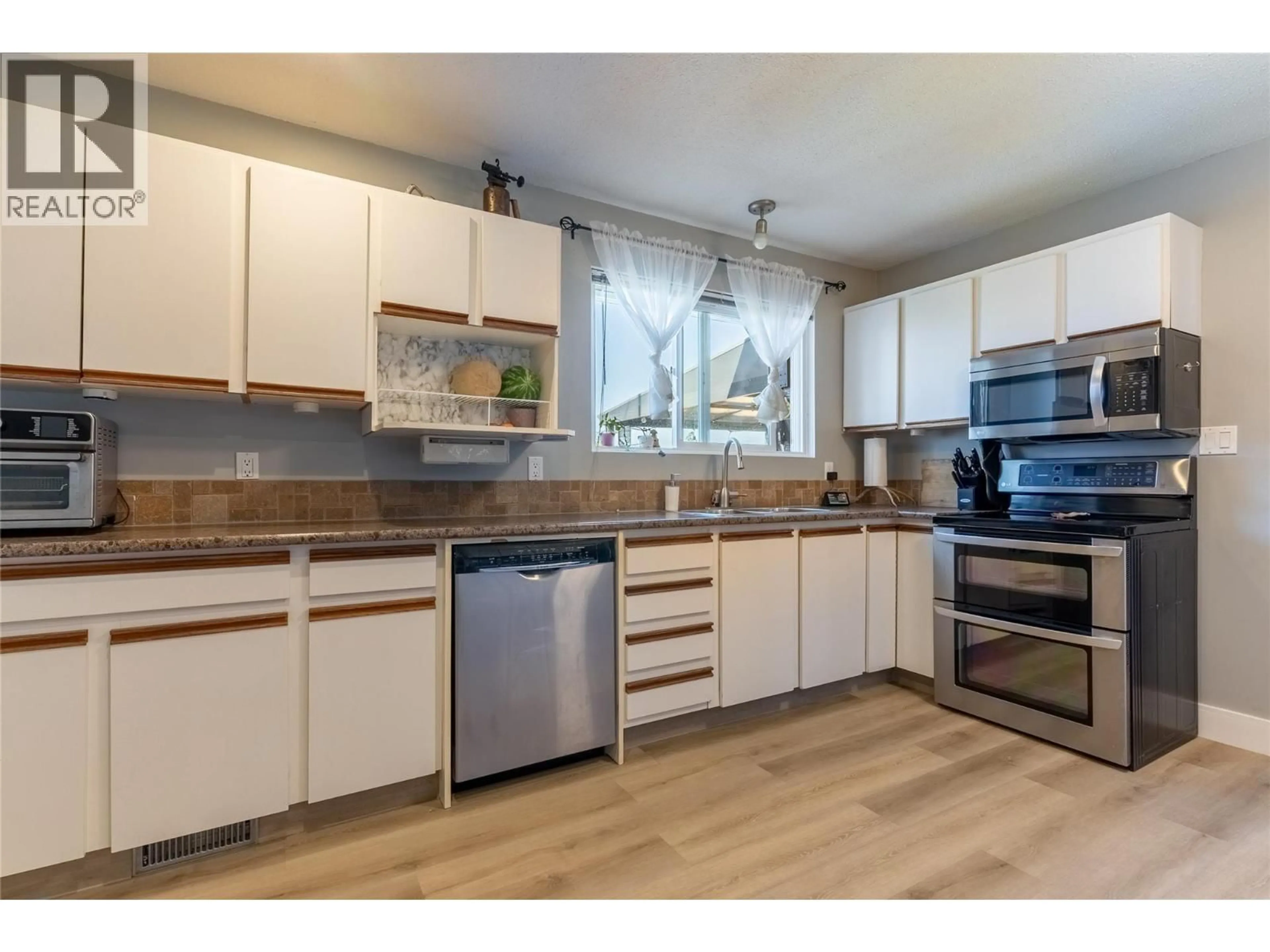 Open concept kitchen, wood/laminate floor for 8 BRECCIA DRIVE, Logan Lake British Columbia V0K1W0