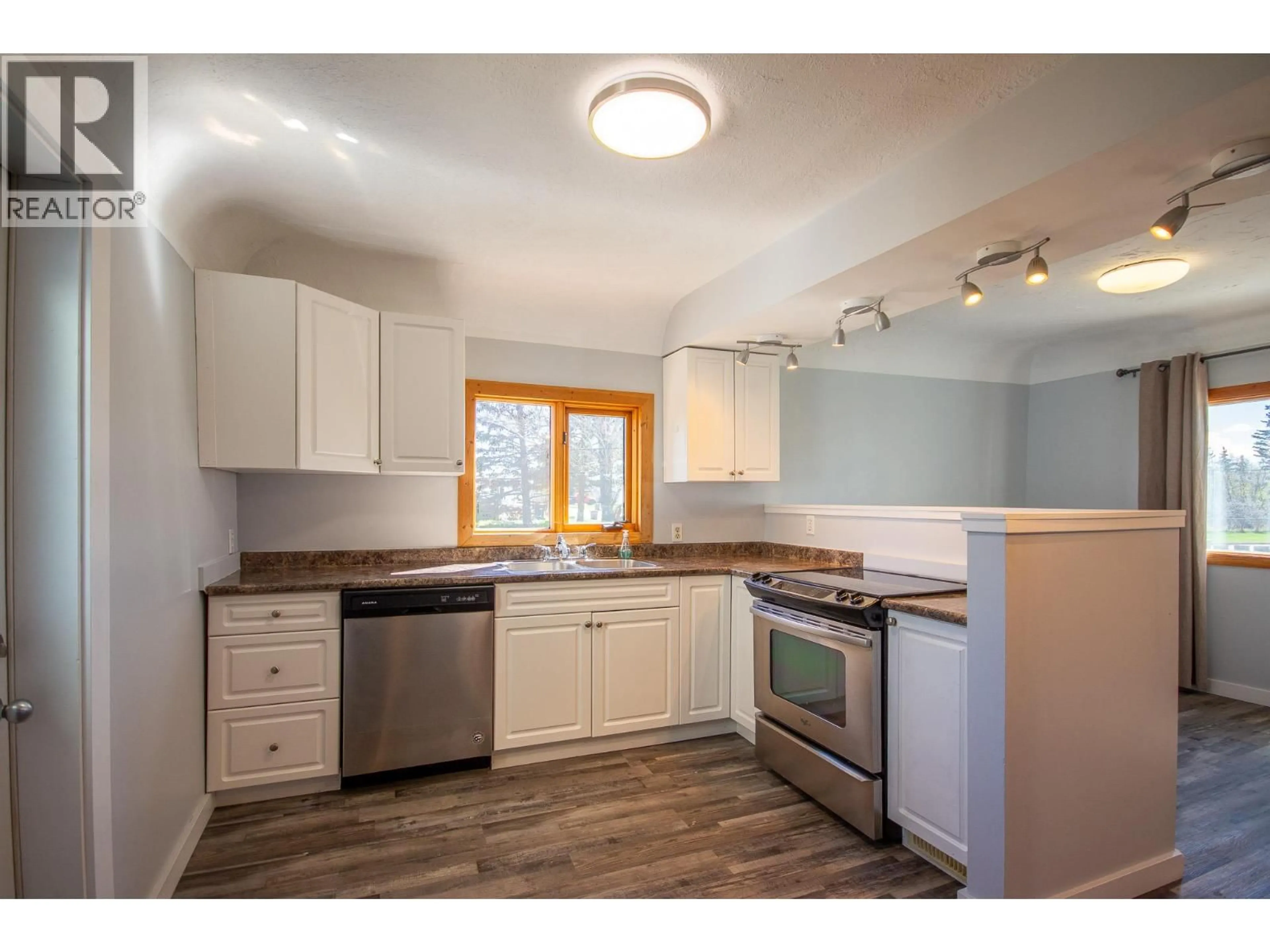 Open concept kitchen, wood/laminate floor for 1600 101 AVENUE, Dawson Creek British Columbia V1G2A9
