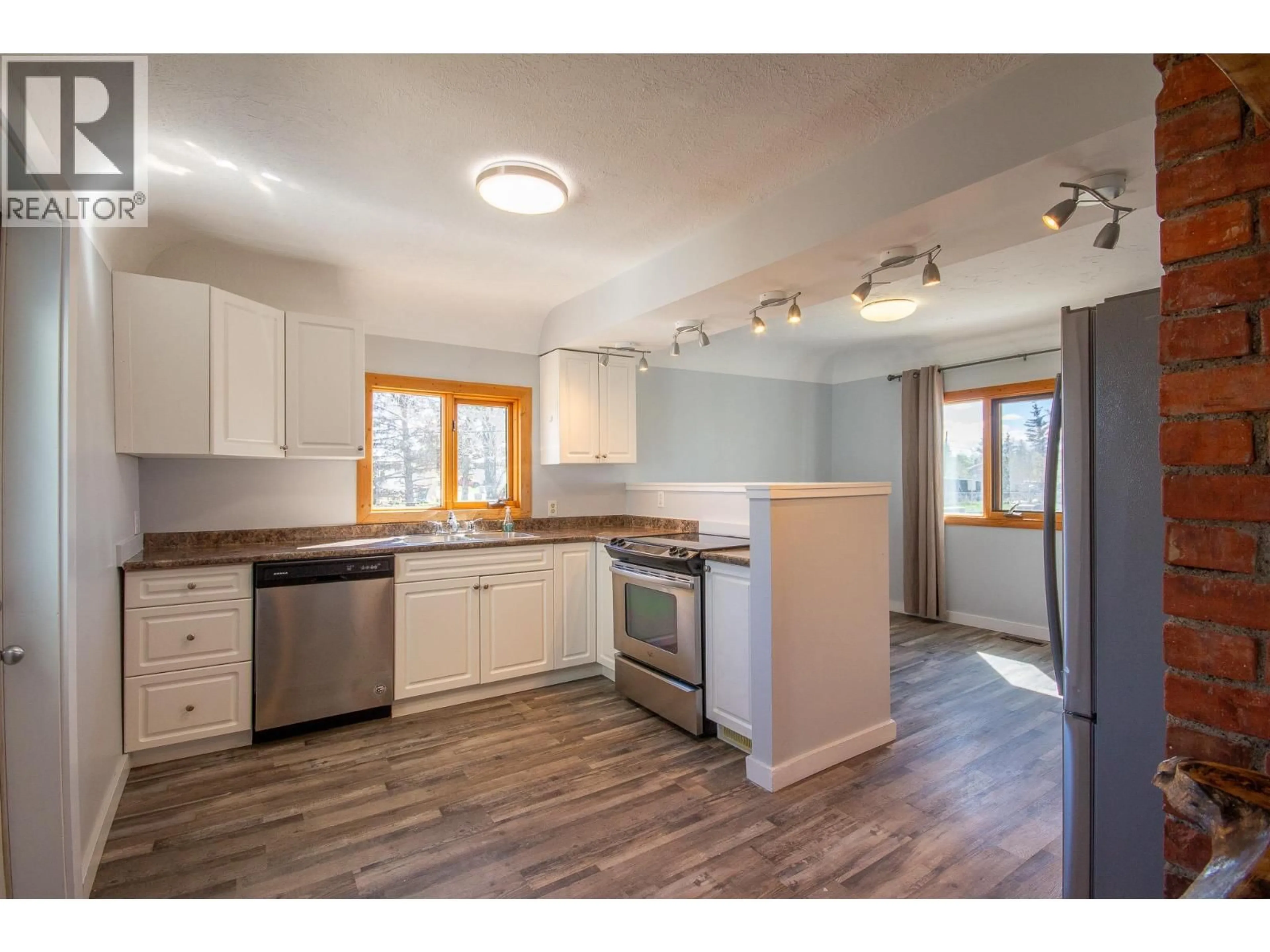 Open concept kitchen, wood/laminate floor for 1600 101 AVENUE, Dawson Creek British Columbia V1G2A9