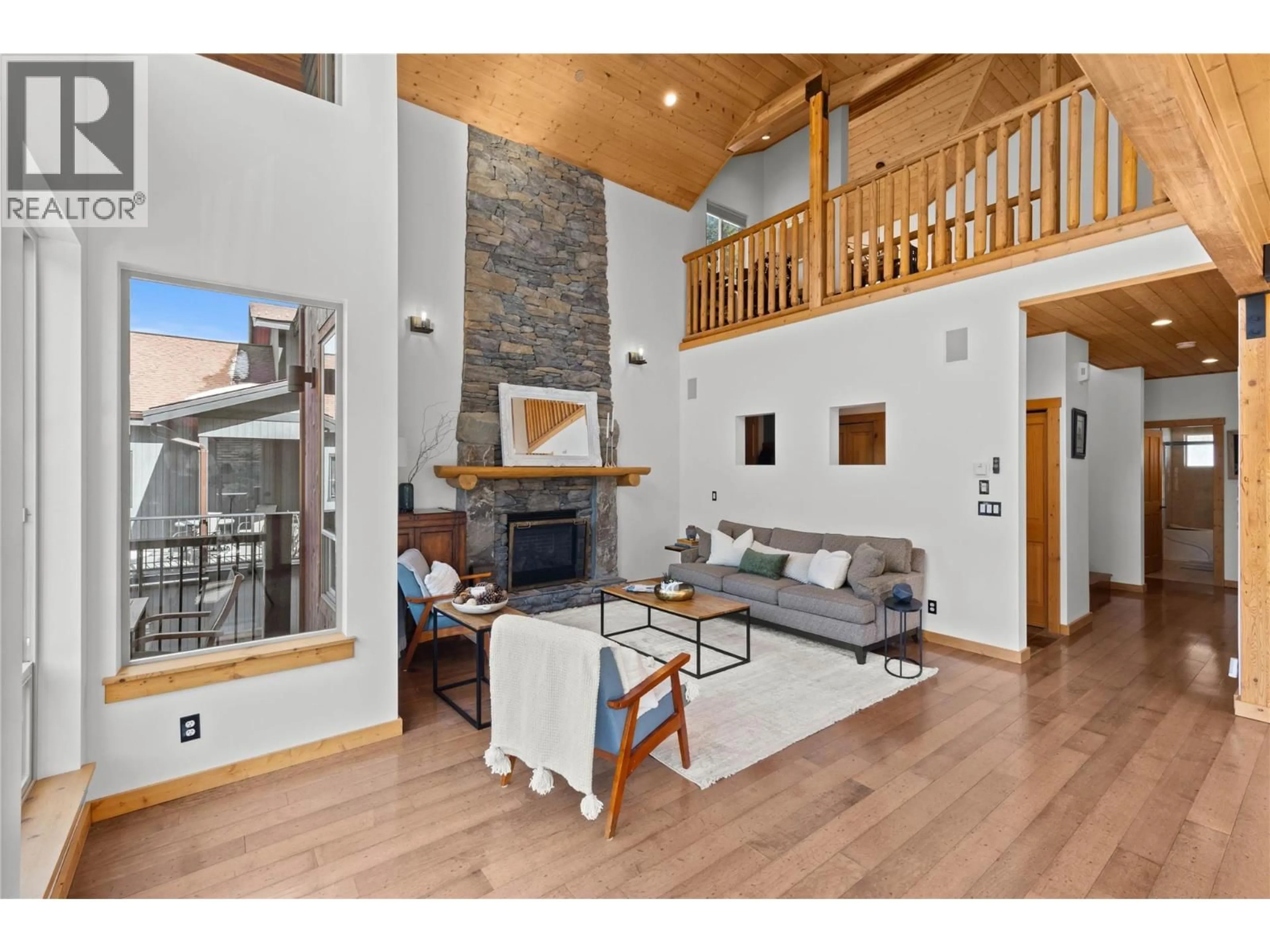 Living room with furniture, wood/laminate floor for 2431 FAIRWAYS DRIVE, Sun Peaks British Columbia V0E5N0