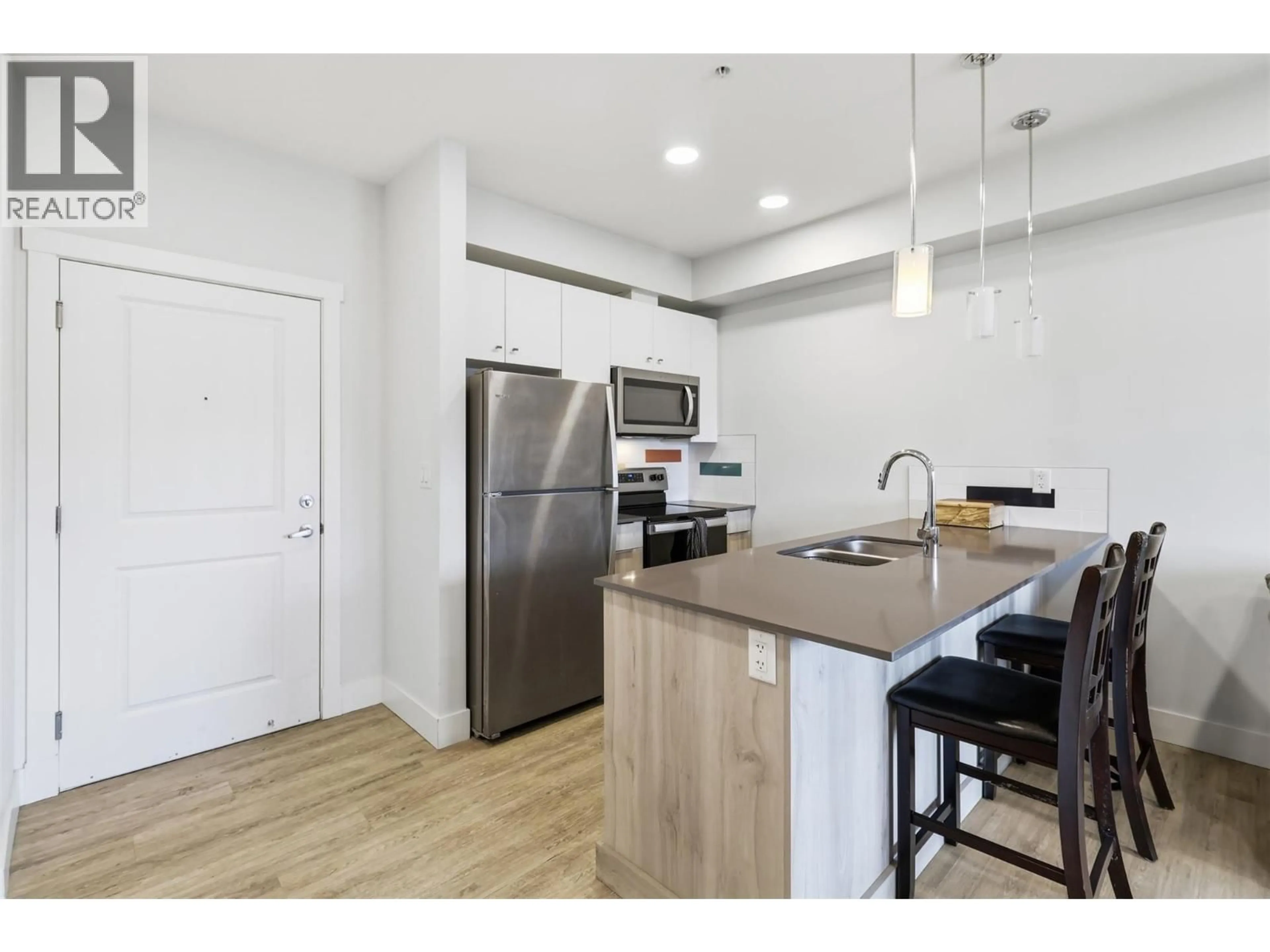 Open concept kitchen, wood/laminate floor for 301 - 107 YEW STREET, Kamloops British Columbia V2B4A1