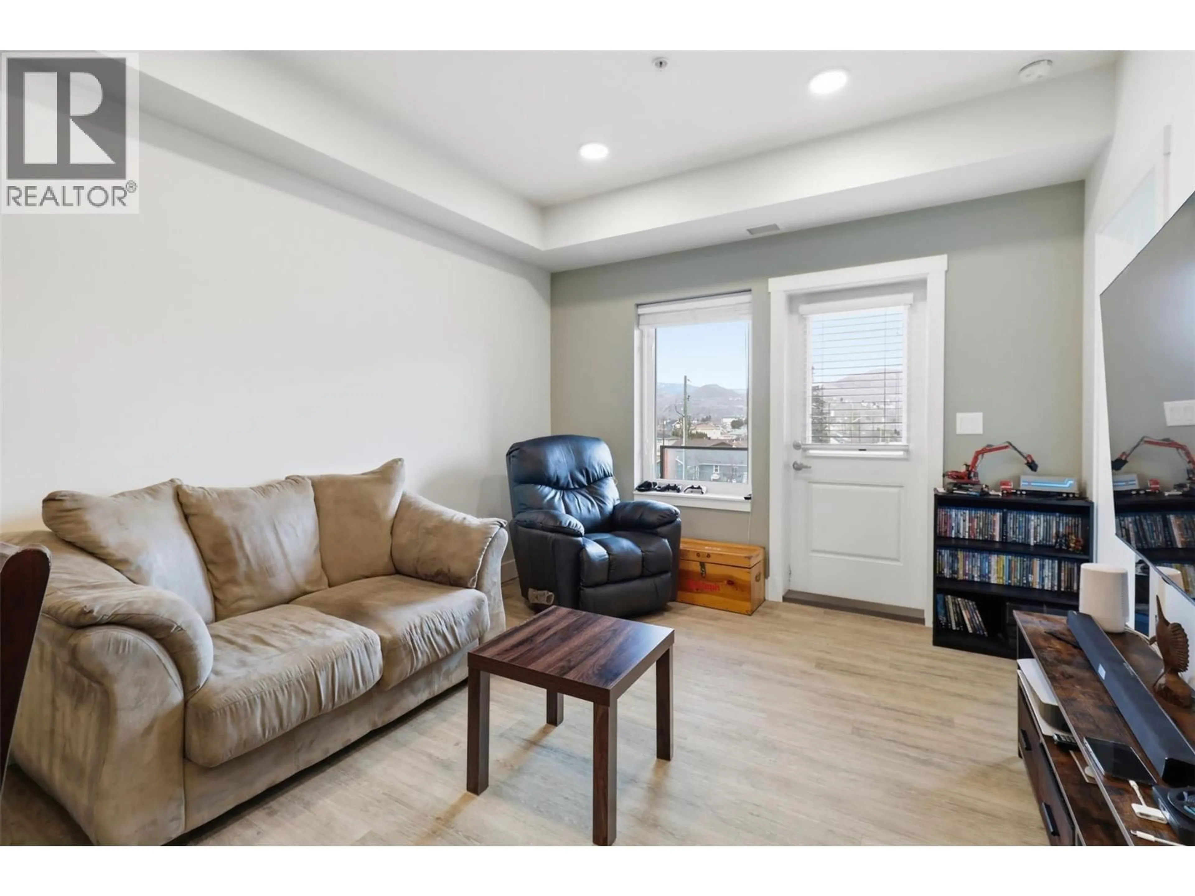 Living room with furniture, wood/laminate floor for 301 - 107 YEW STREET, Kamloops British Columbia V2B4A1