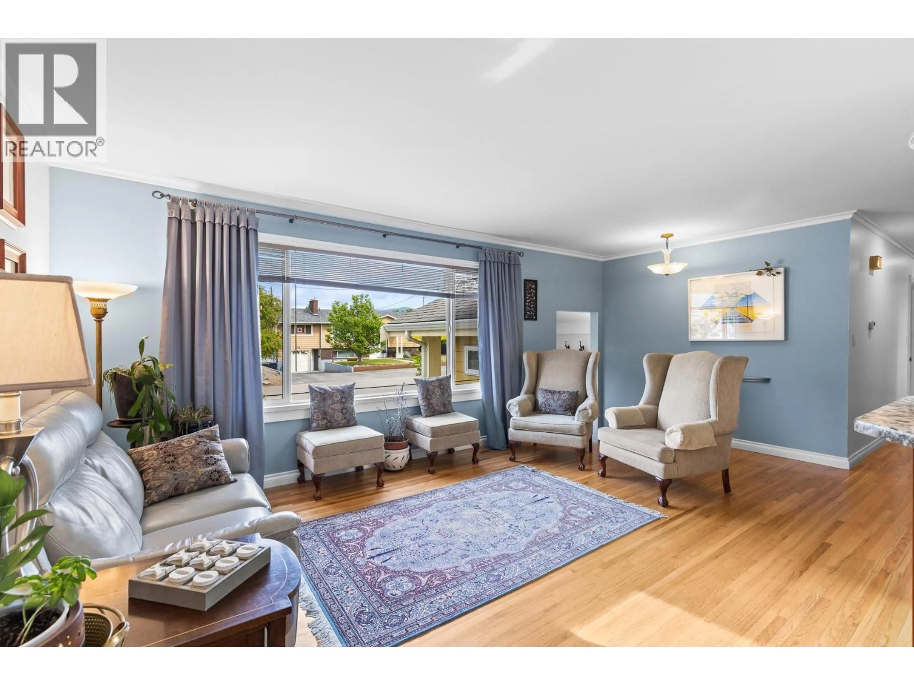 Living room with furniture, wood/laminate floor for 740 ACE ROAD, Kelowna British Columbia V1X4C5
