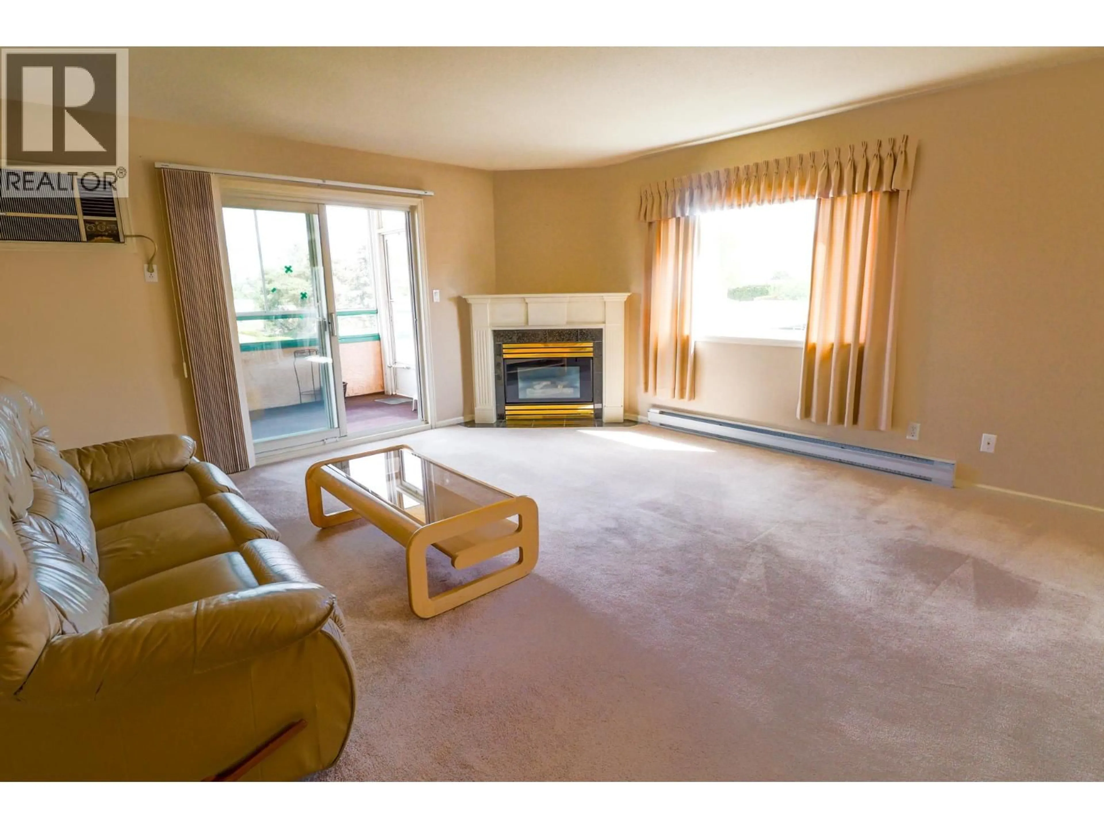 Living room with furniture, carpet floor for 208 - 8907 PINEO COURT, Summerland British Columbia V0H1Z5