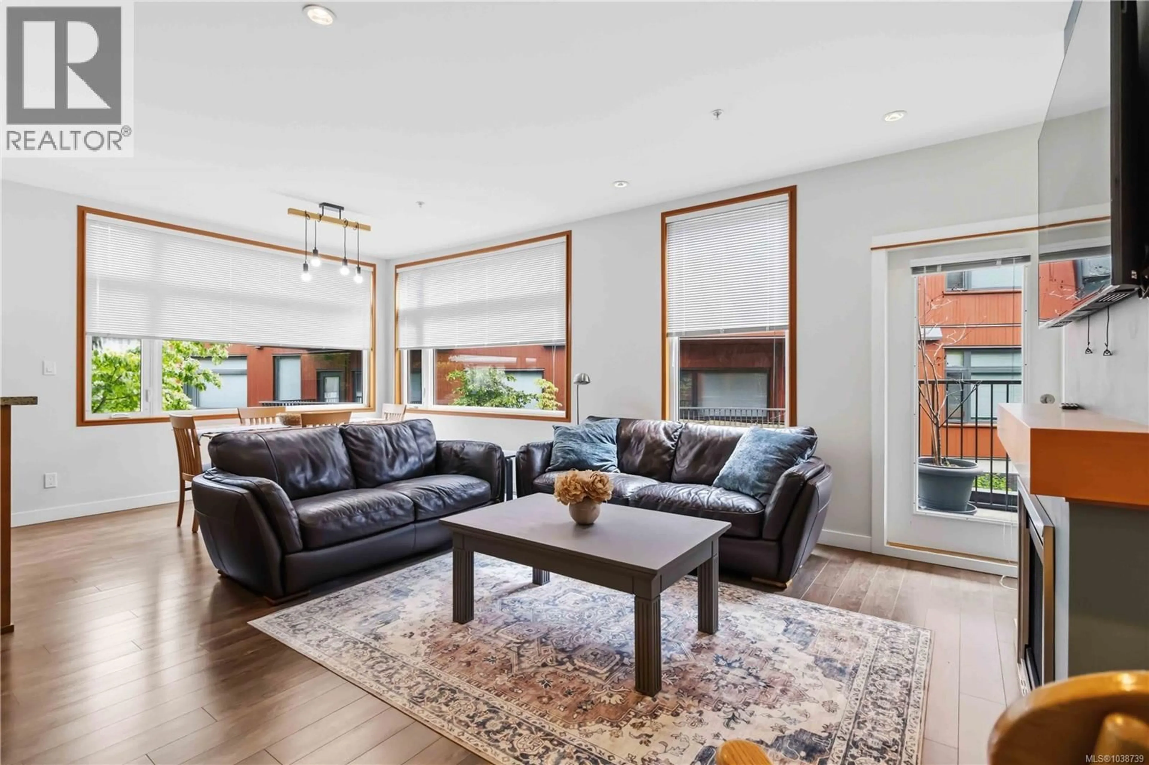 Living room with furniture, wood/laminate floor for 207 - 150 NURSERY HILL DRIVE, View Royal British Columbia V9B0P2