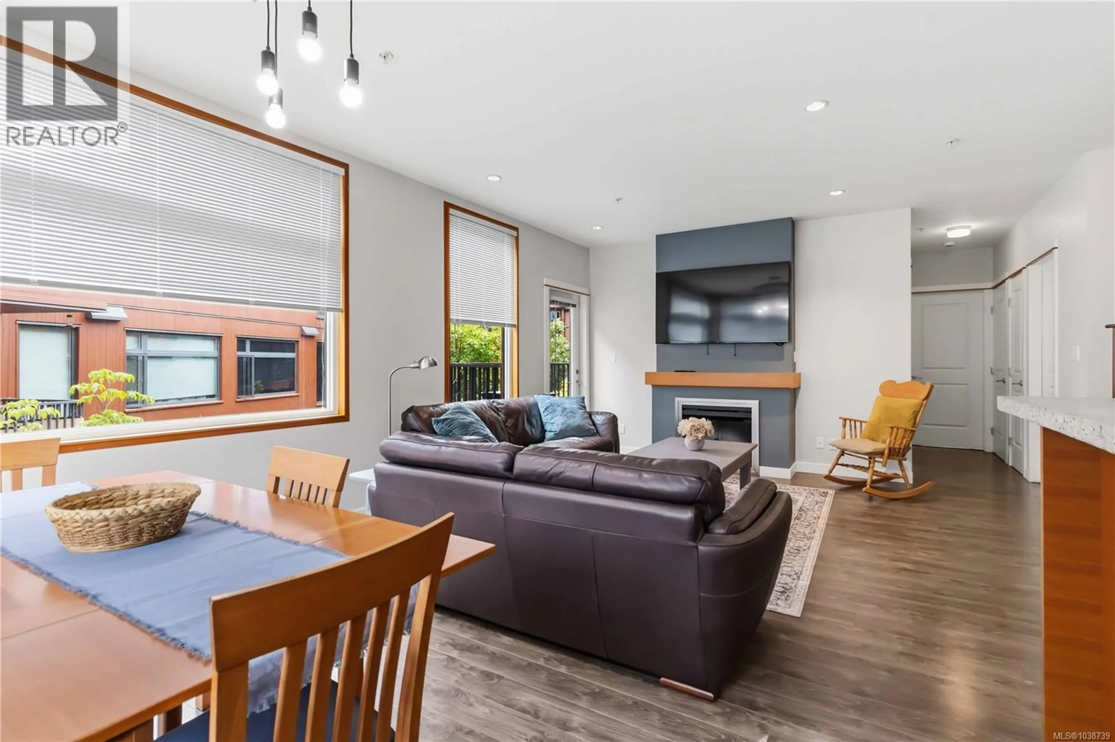 Living room with furniture, wood/laminate floor for 207 - 150 NURSERY HILL DRIVE, View Royal British Columbia V9B0P2