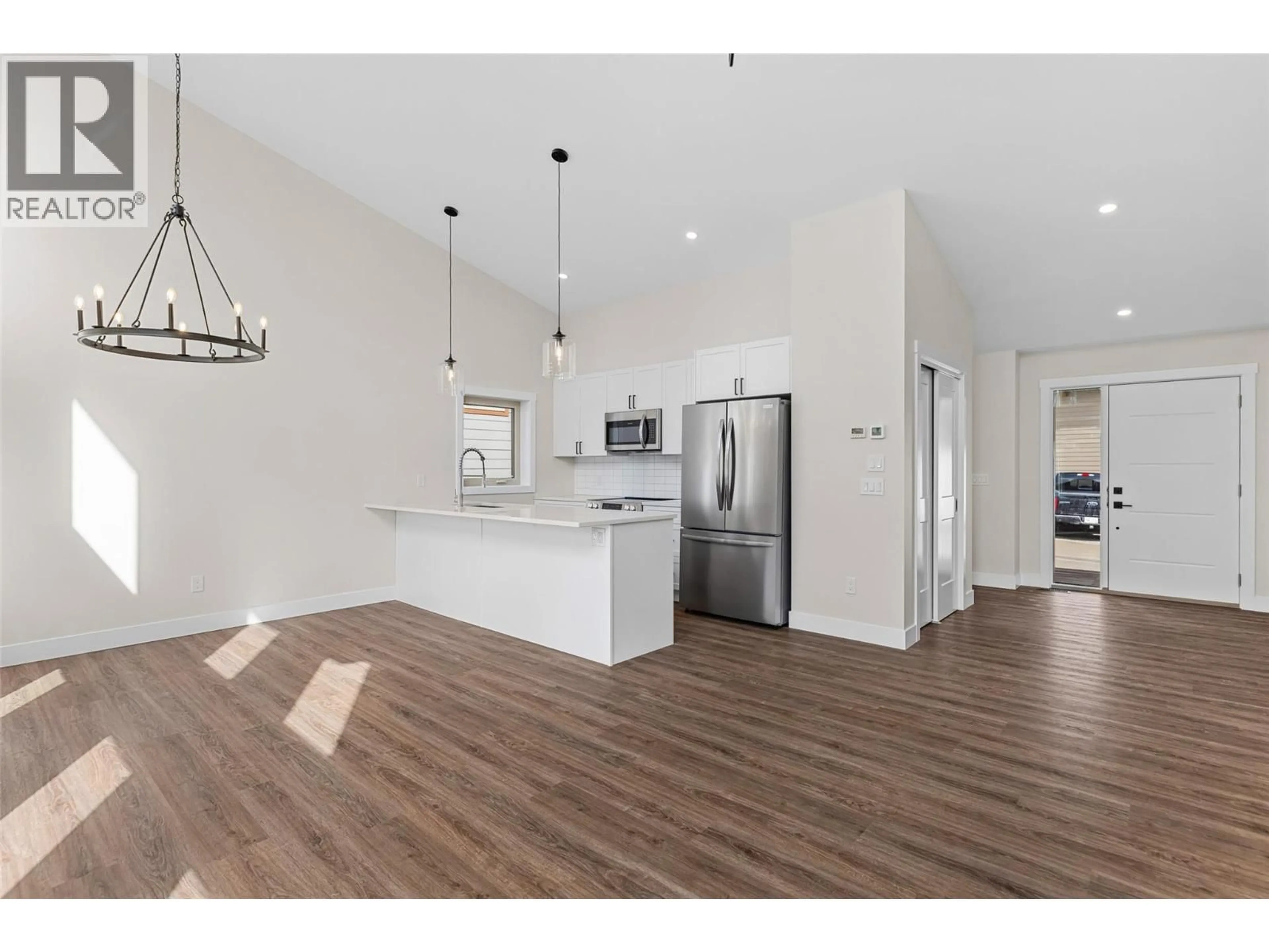 Open concept kitchen, wood/laminate floor for 1208 SWANSEA CRESCENT, Windermere British Columbia V0B2L0