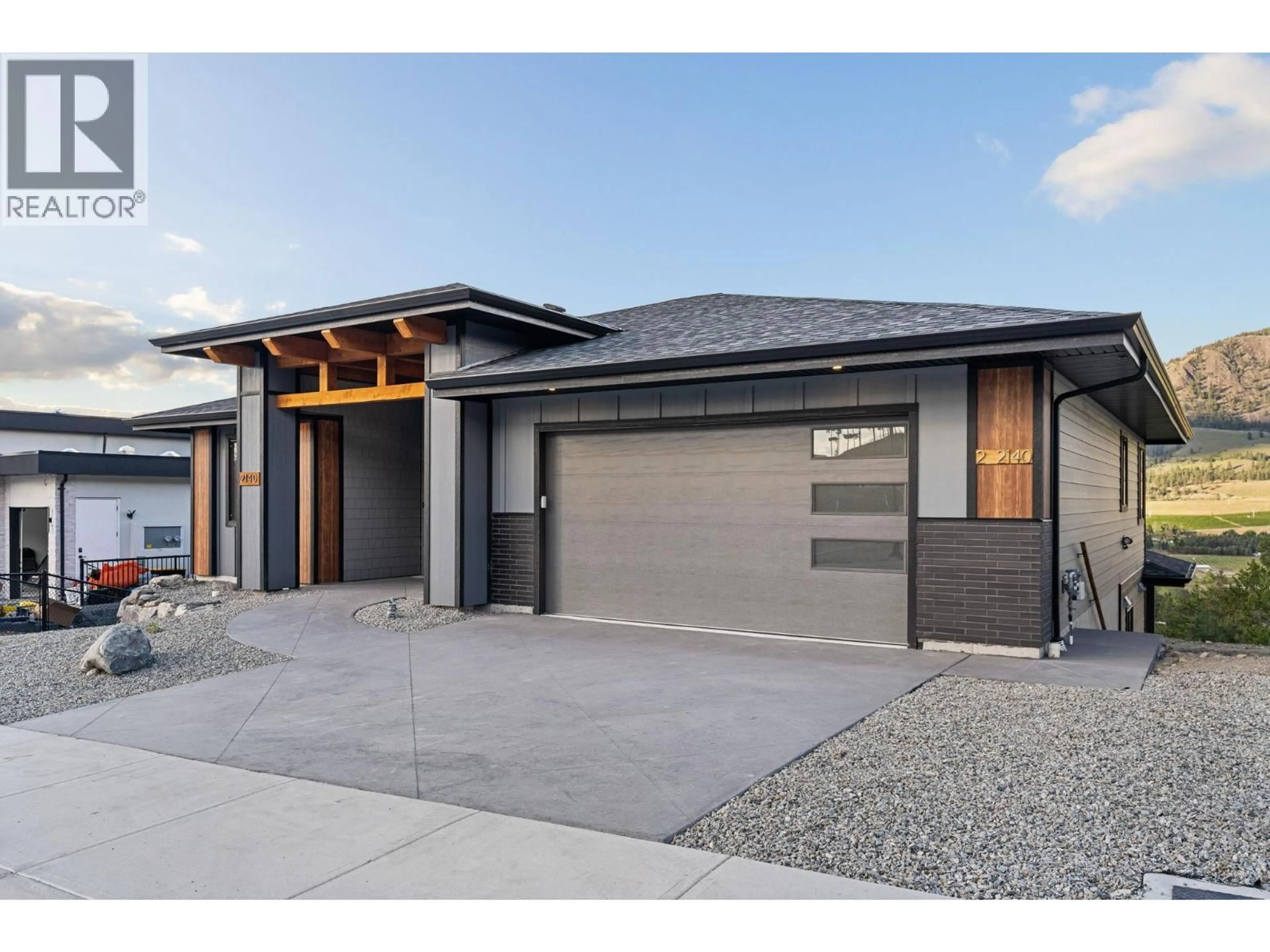 Home with brick exterior material, street for 2140 MONTENEGRO DRIVE, Kelowna British Columbia V1P0B2