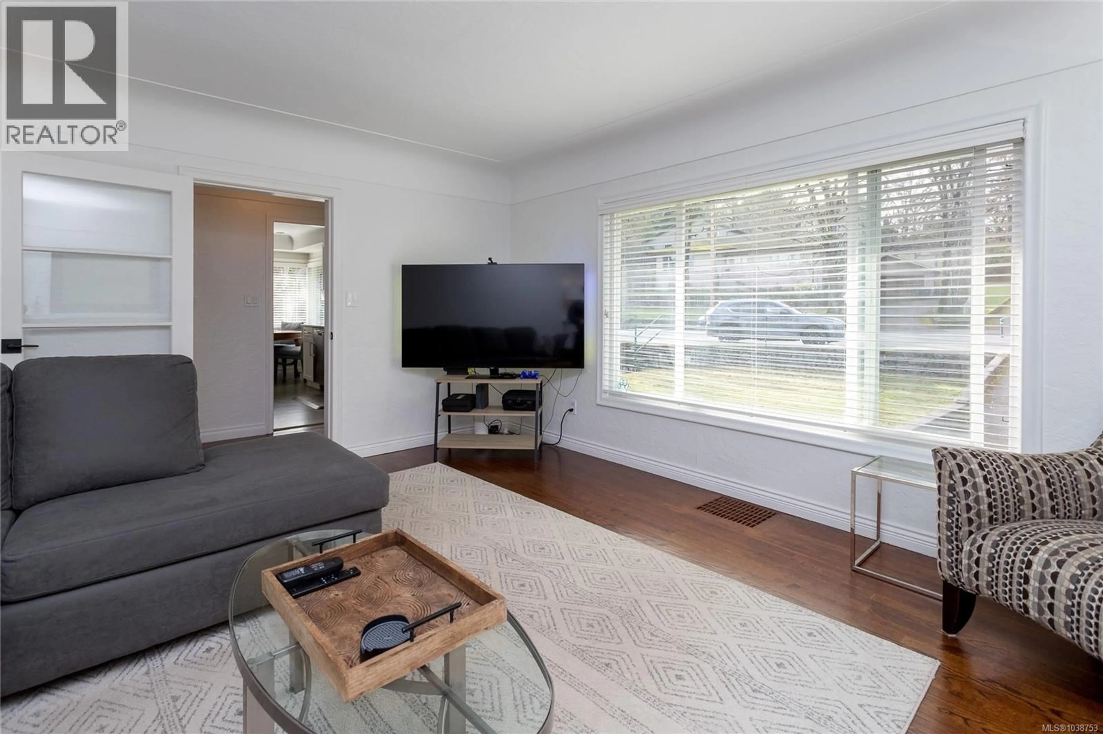 Living room with furniture, wood/laminate floor for 4121 QUADRA STREET, Saanich British Columbia V8X1L1