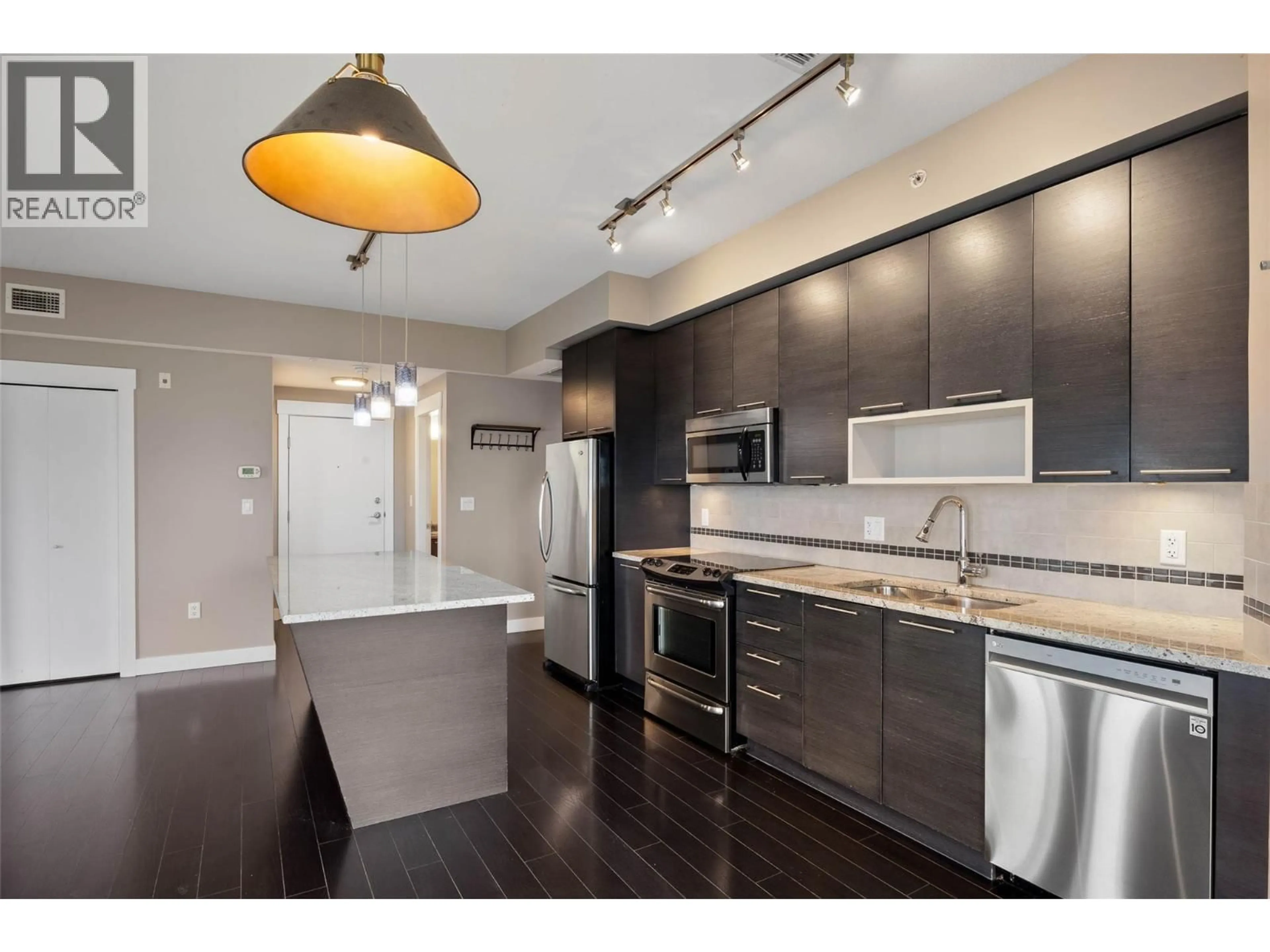 Open concept kitchen, wood/laminate floor for 2404 - 1030 TALASA WAY, Kamloops British Columbia V2H0C3
