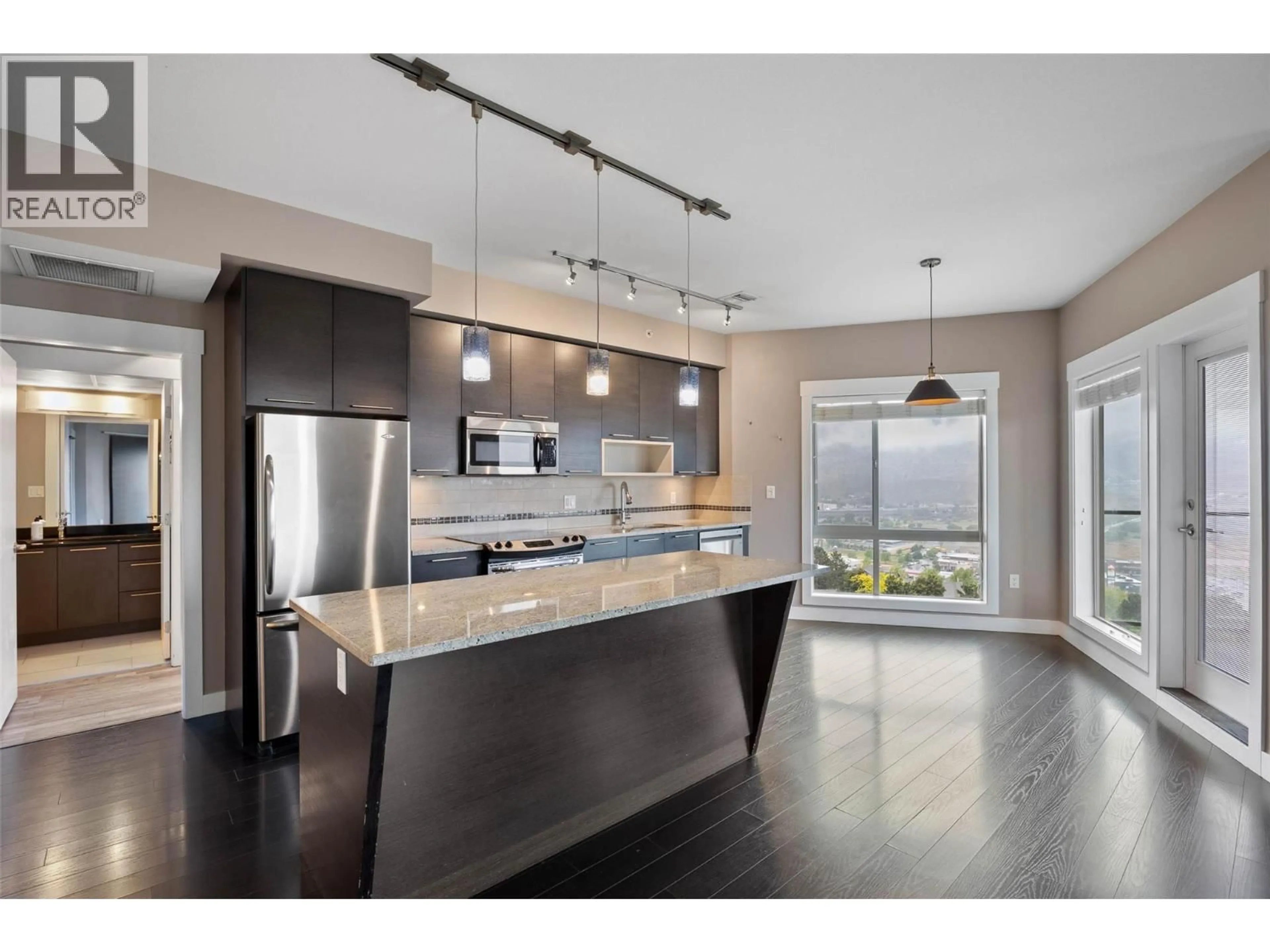 Open concept kitchen, wood/laminate floor for 2404 - 1030 TALASA WAY, Kamloops British Columbia V2H0C3