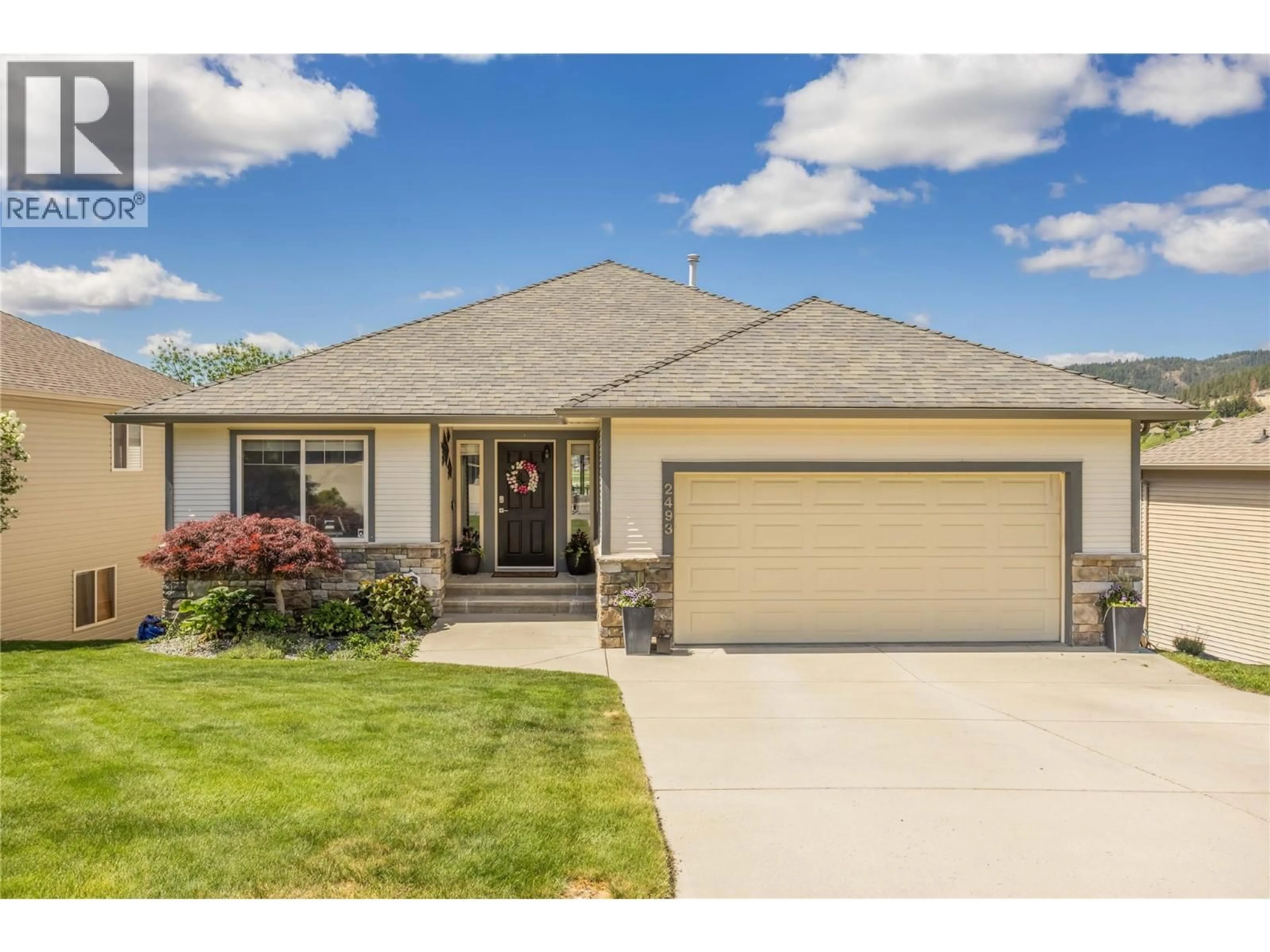 Home with vinyl exterior material, street for 2493 IRONRIDGE ROAD, West Kelowna British Columbia V4T2Y4