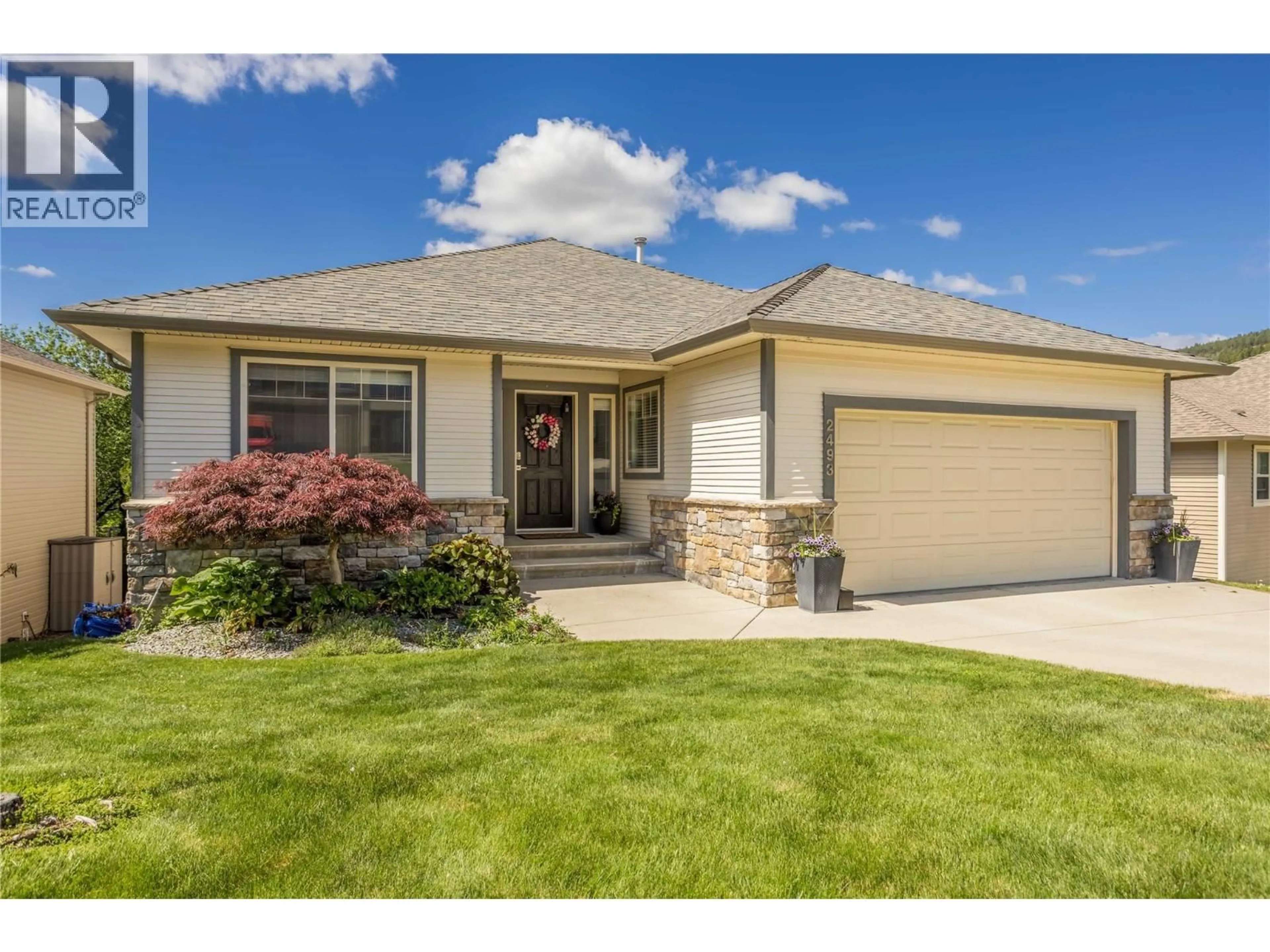 Home with vinyl exterior material, street for 2493 IRONRIDGE ROAD, West Kelowna British Columbia V4T2Y4