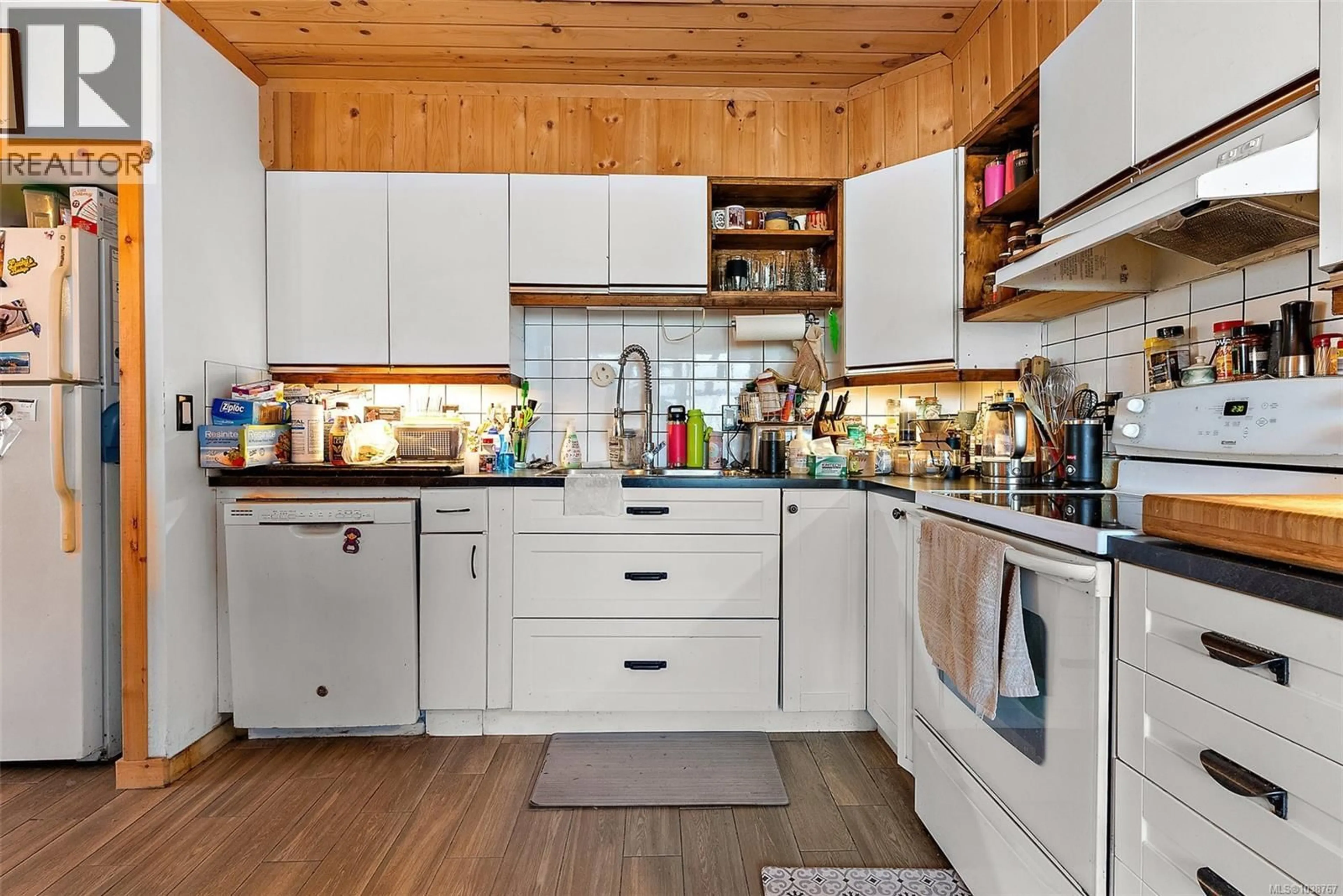 Open concept kitchen, wood/laminate floor for 3176 BALFOUR AVENUE, Victoria British Columbia V9A1S1