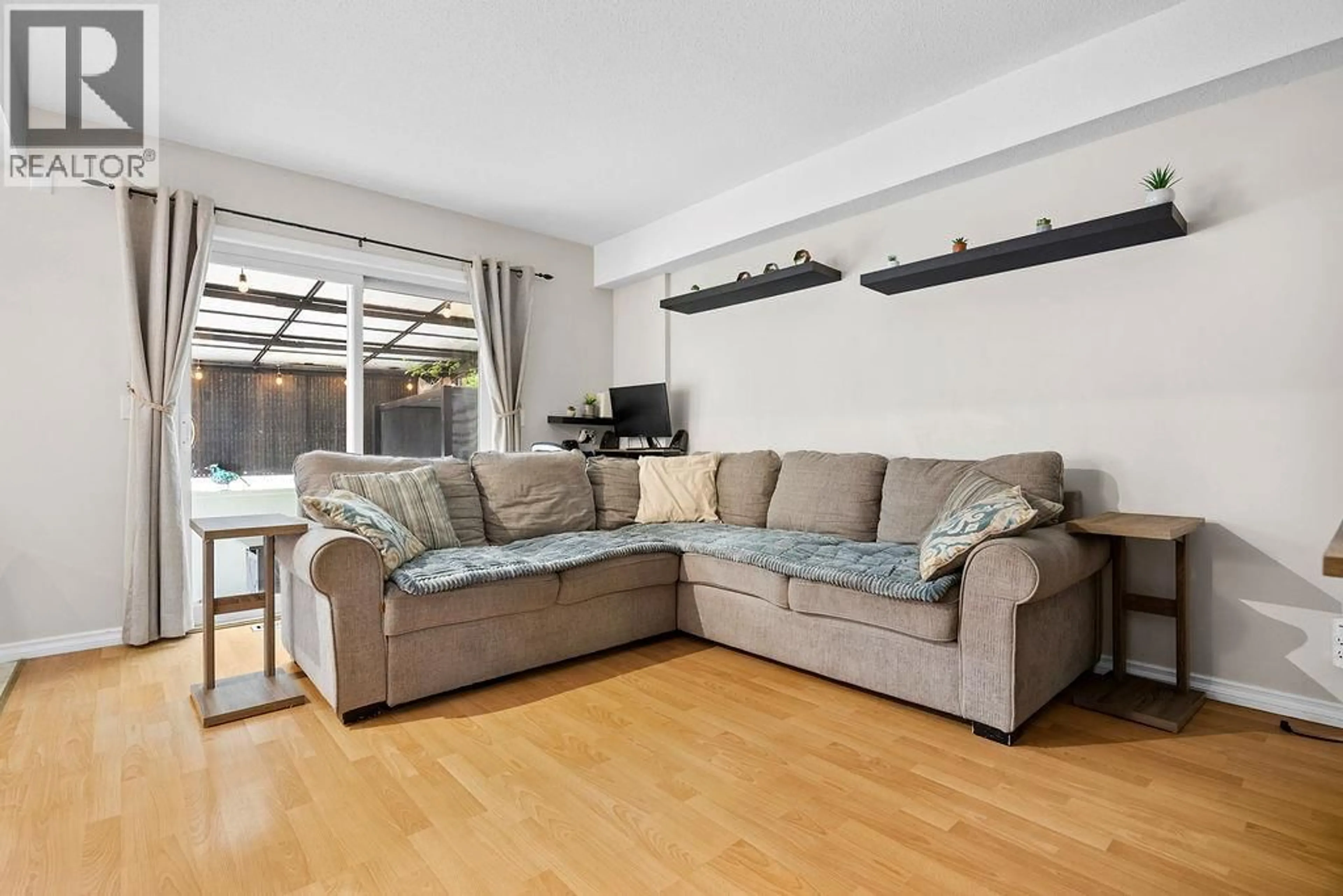 Living room with furniture, wood/laminate floor for Unit E - 4008 24 AVENUE, Vernon British Columbia V1T1M2