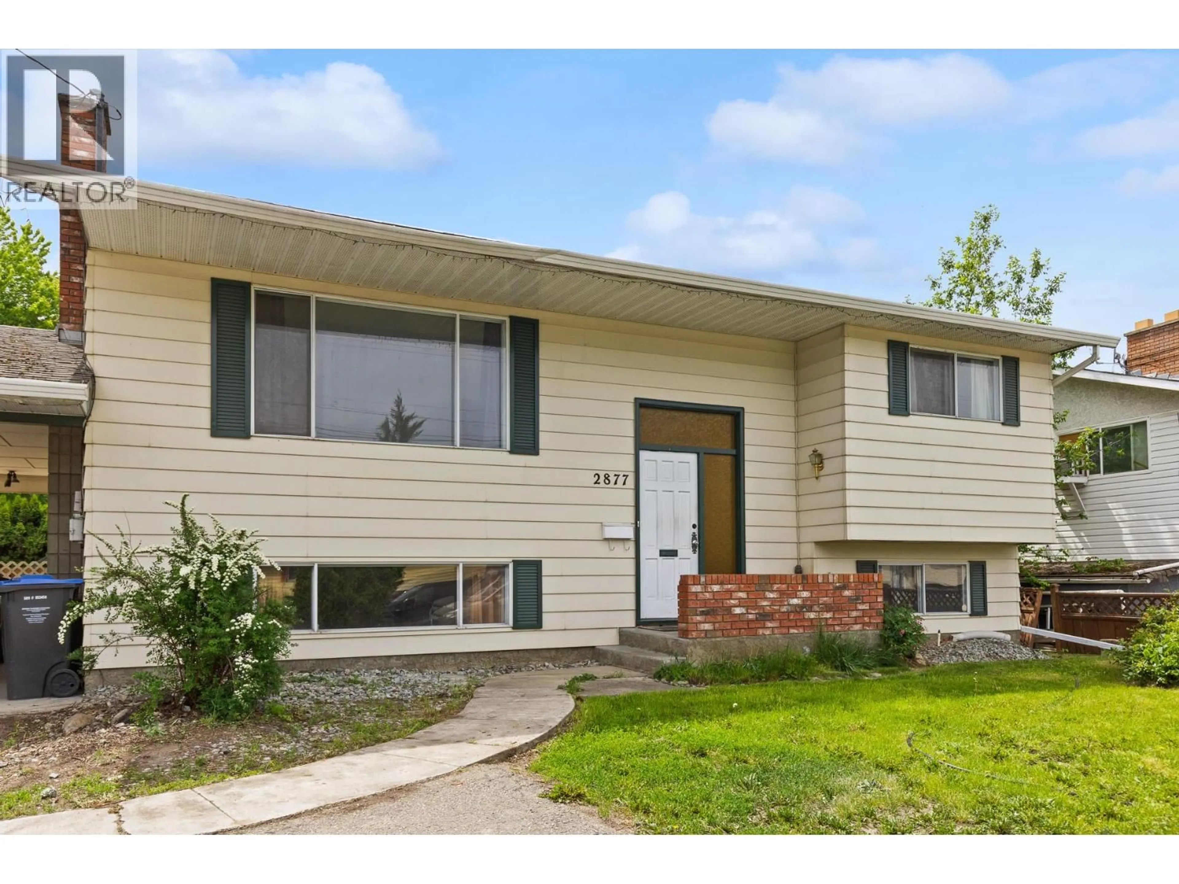 Home with vinyl exterior material, street for 2877 SPRINGFIELD ROAD, Kelowna British Columbia V1X4M5