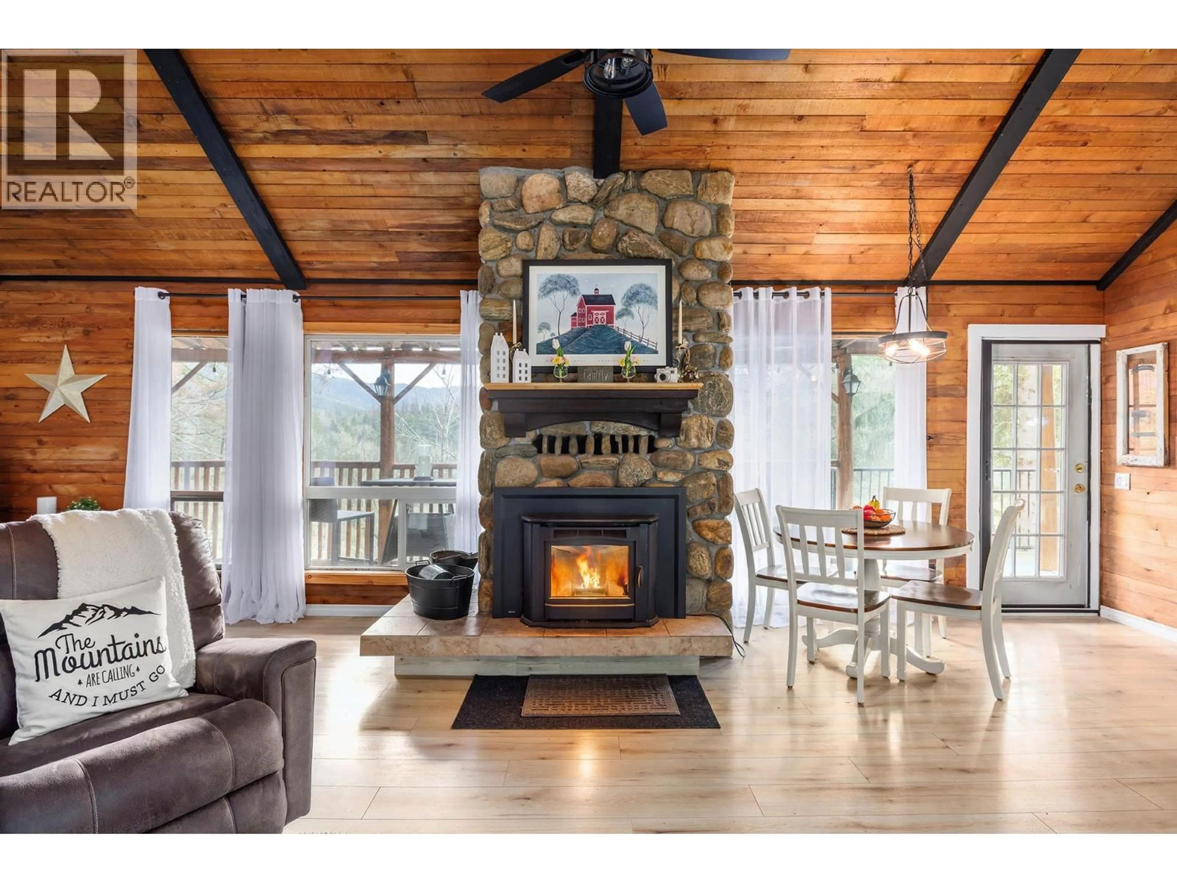 Living room with furniture, wood/laminate floor for 11251 THREE FORKS ROAD, Kelowna British Columbia V1P1J8