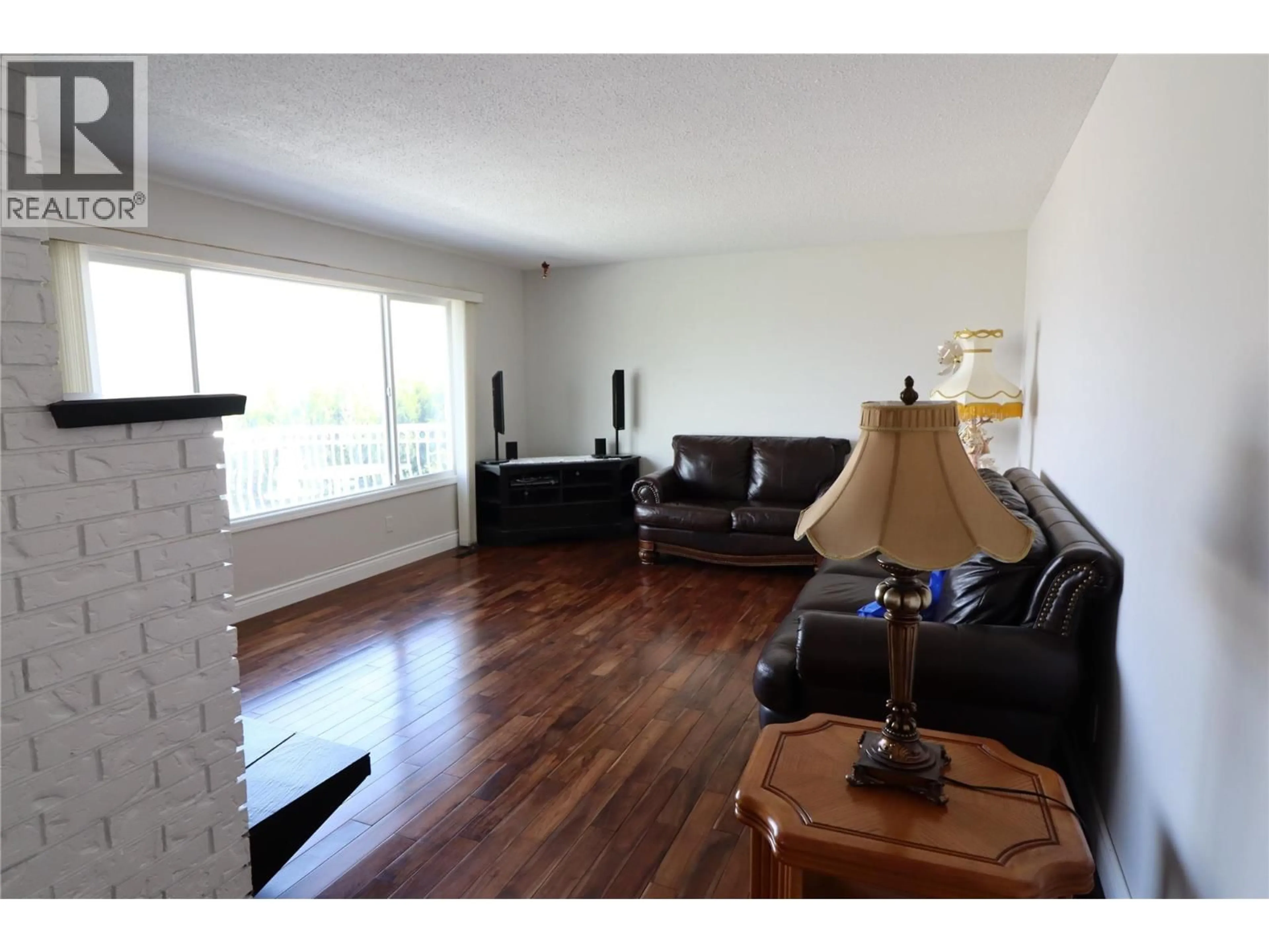 Living room with furniture, wood/laminate floor for 136 GREENSTONE DRIVE, Kamloops British Columbia V2C1N5