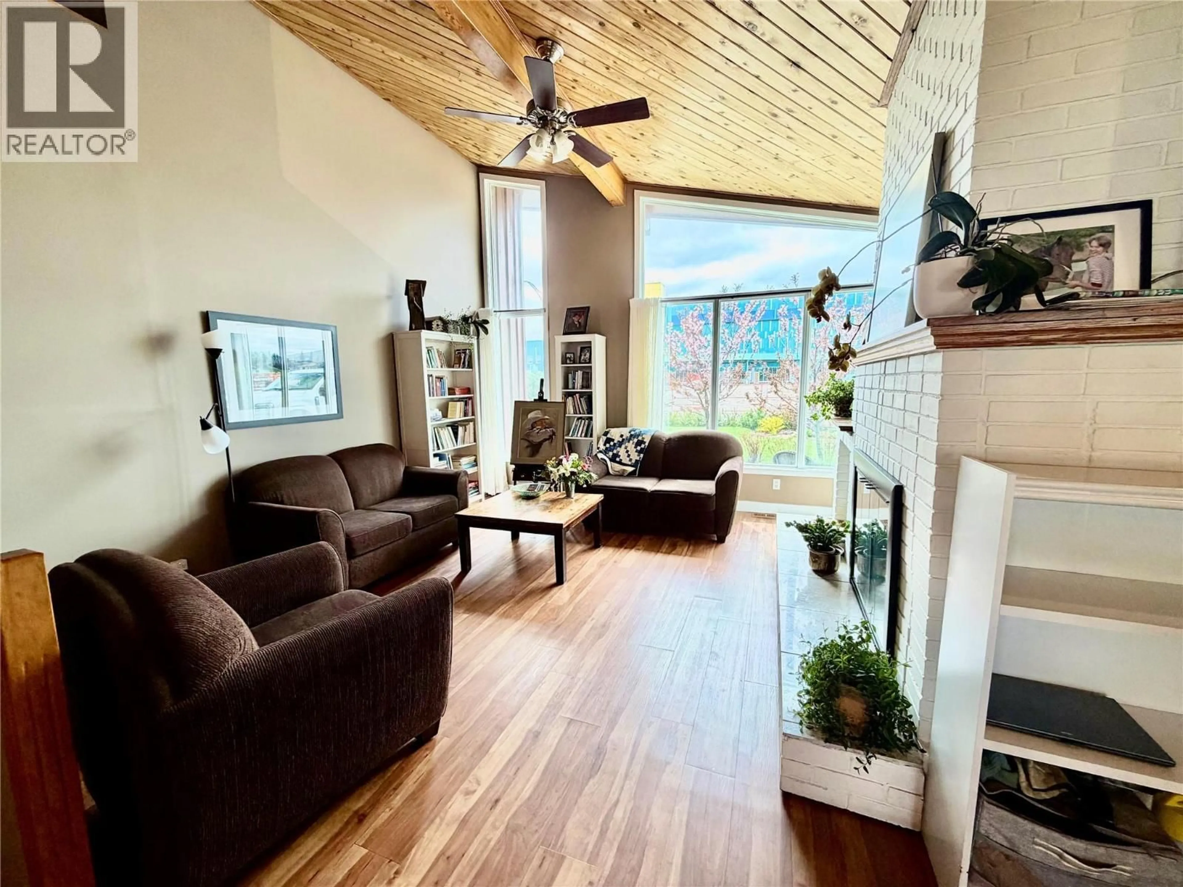 Living room with furniture, wood/laminate floor for 924 112 AVENUE, Dawson Creek British Columbia V1G2Y3