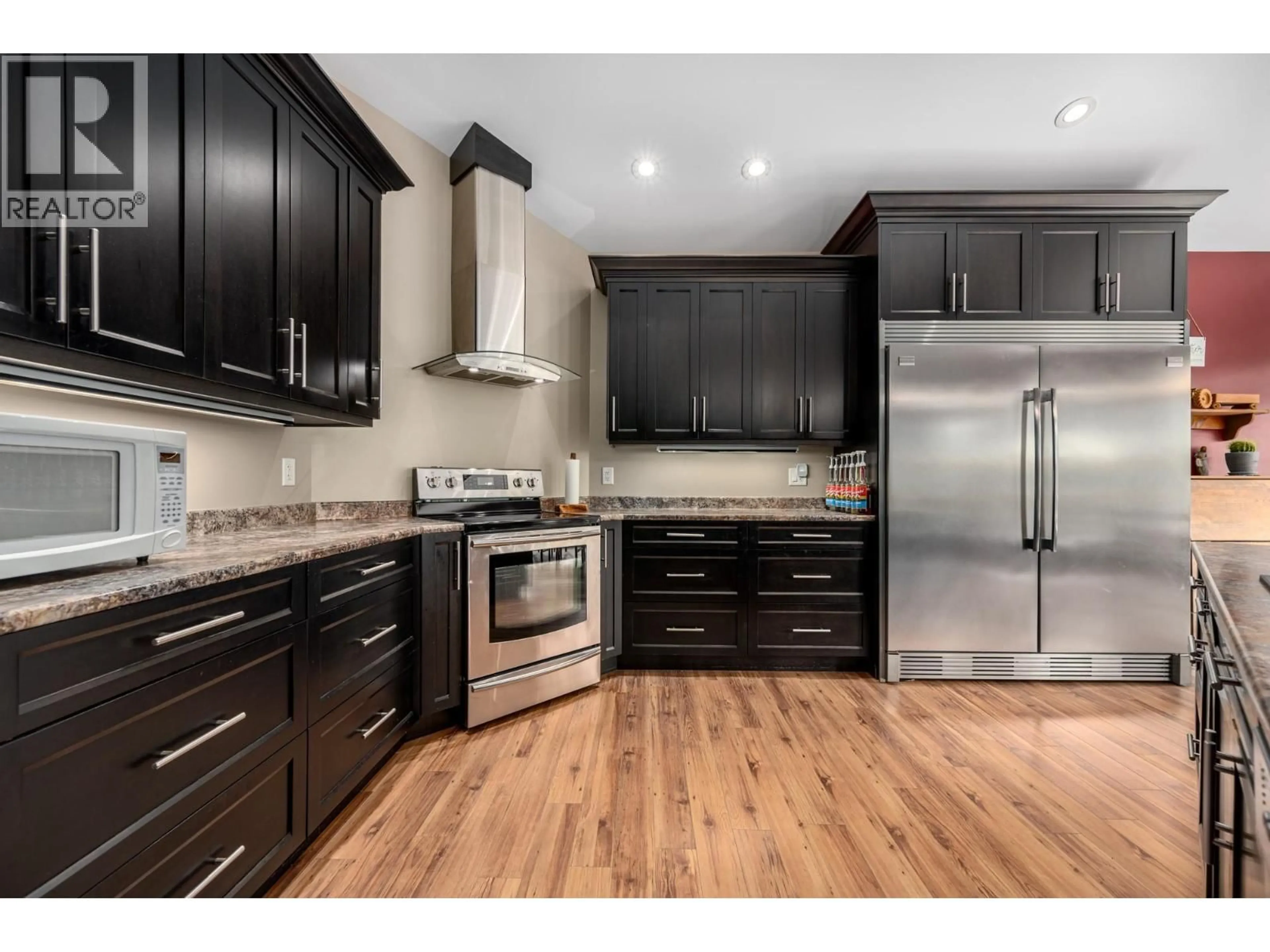 Open concept kitchen, wood/laminate floor for 787 CRESCENT BAY ROAD, Nakusp British Columbia V0G1R1