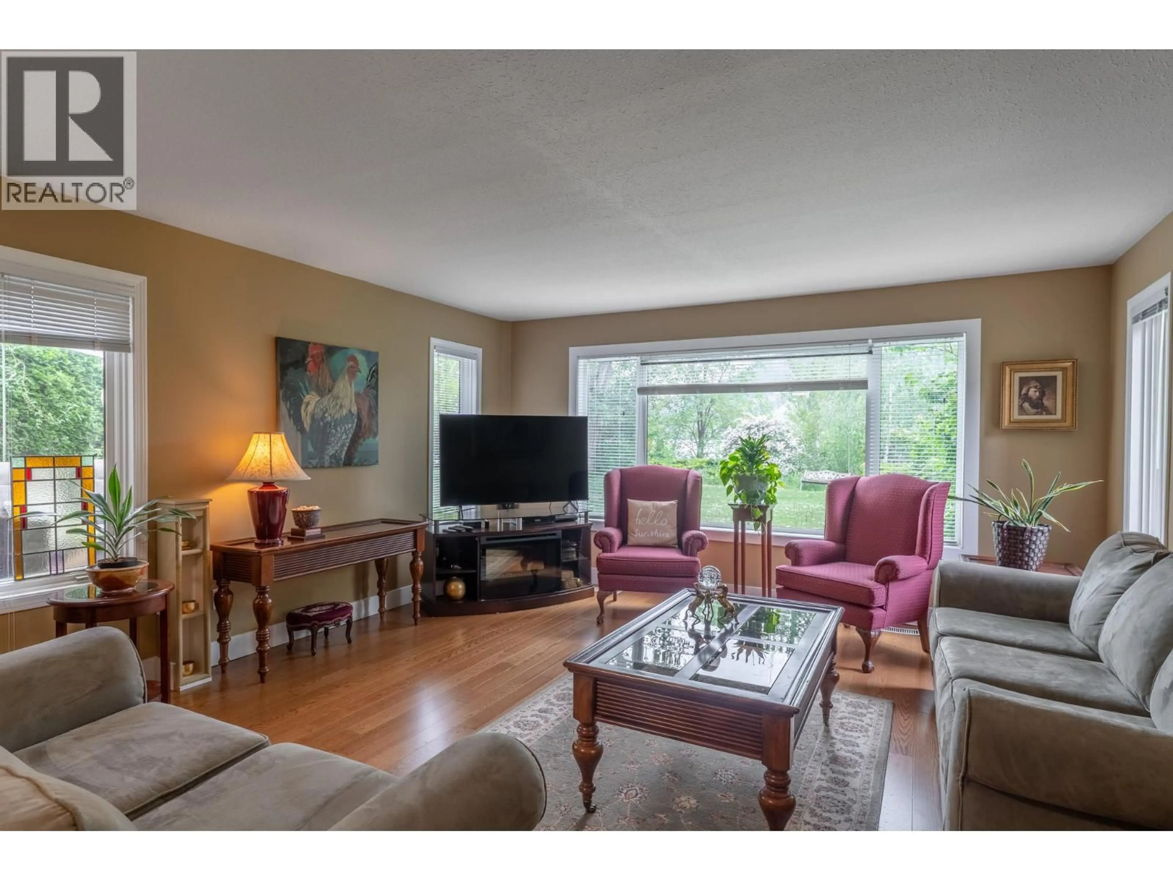 Living room with furniture, wood/laminate floor for 1312 - 415 COMMONWEALTH ROAD, Kelowna British Columbia V4V1P4