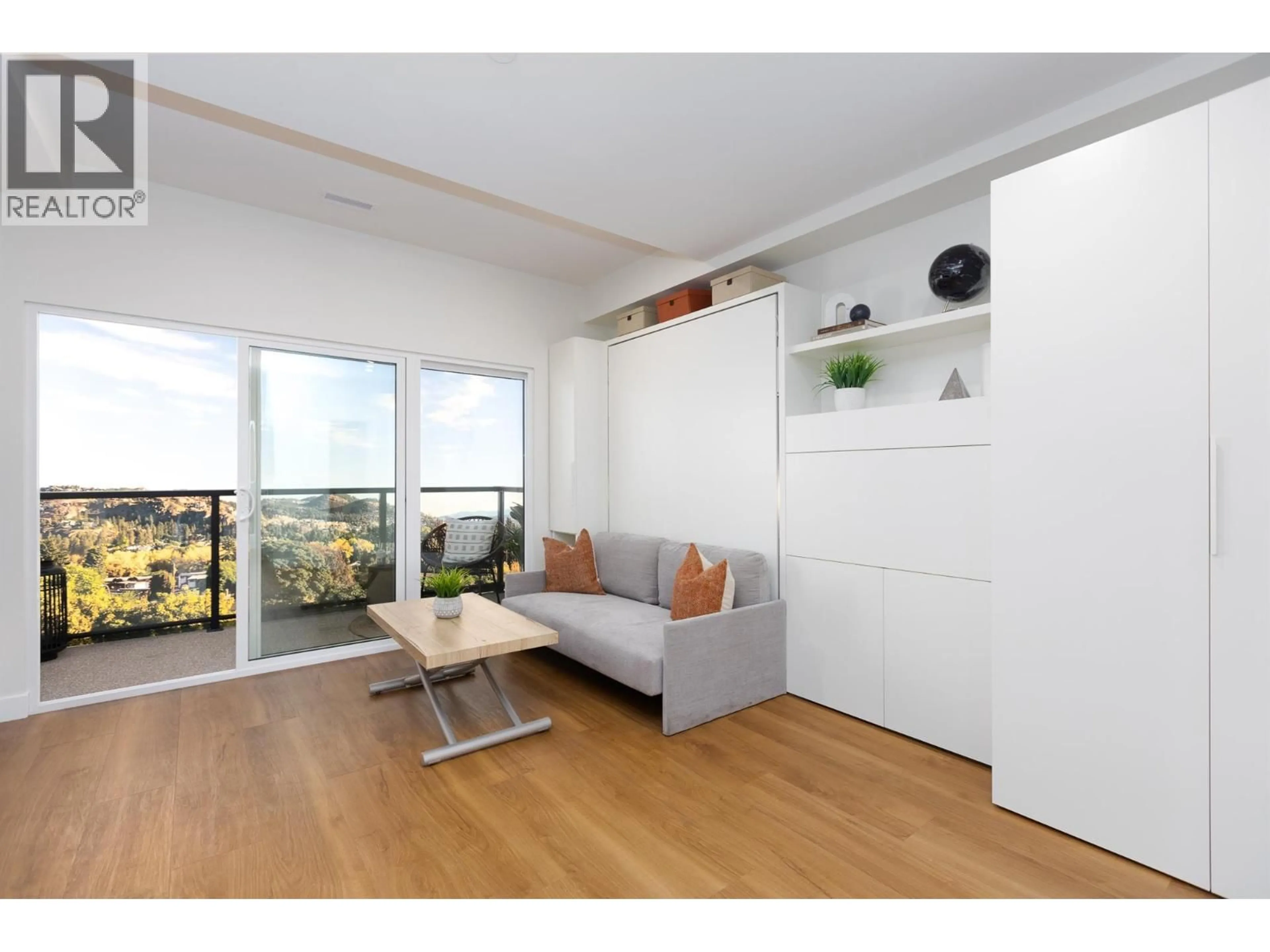 Living room with furniture, wood/laminate floor for 205 - 1281 PRIDHAM AVENUE, Kelowna British Columbia V1Y6B3
