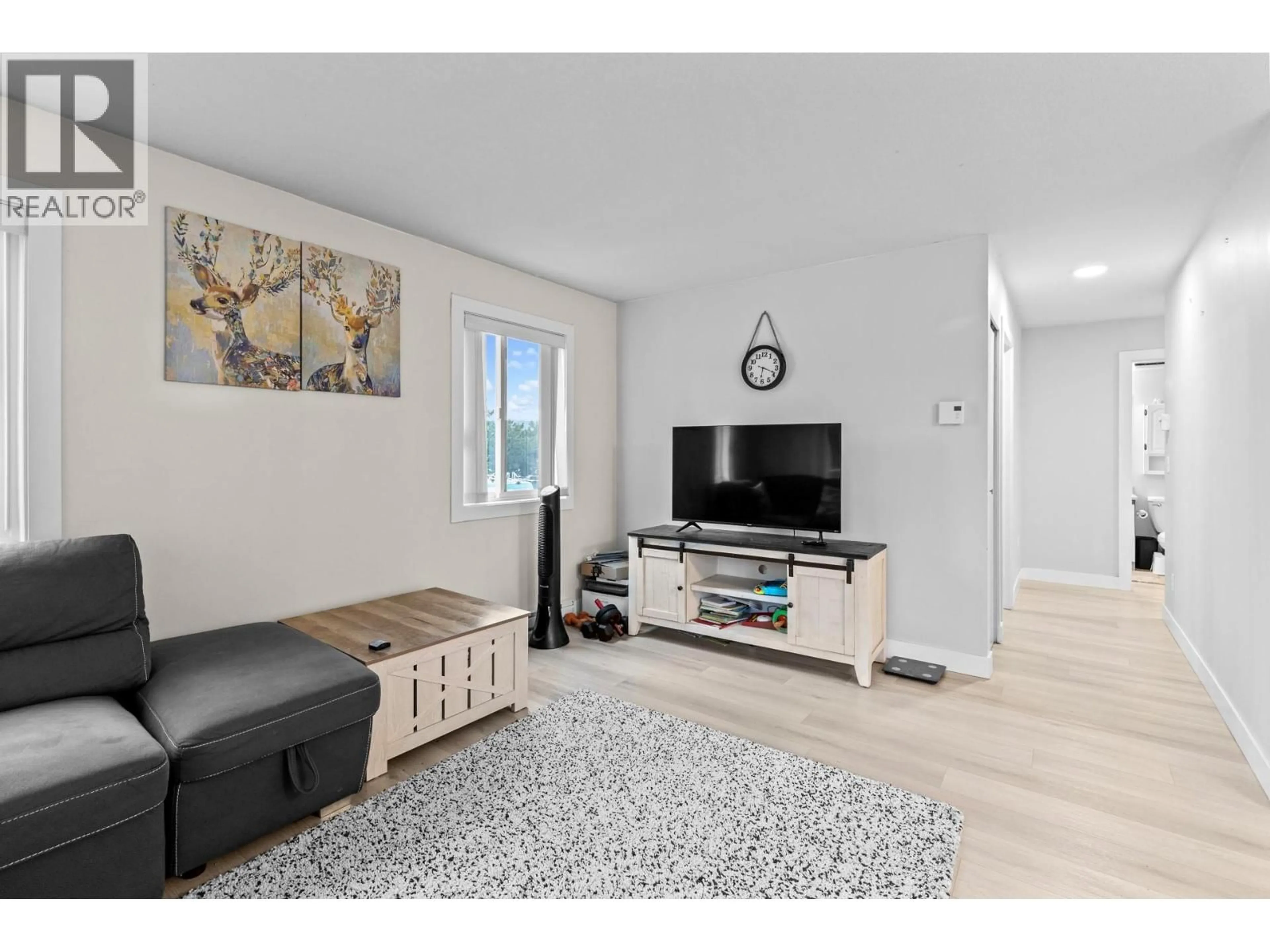 Living room with furniture, wood/laminate floor for 206 - 2025 BARON ROAD, Kelowna British Columbia V1X7G3