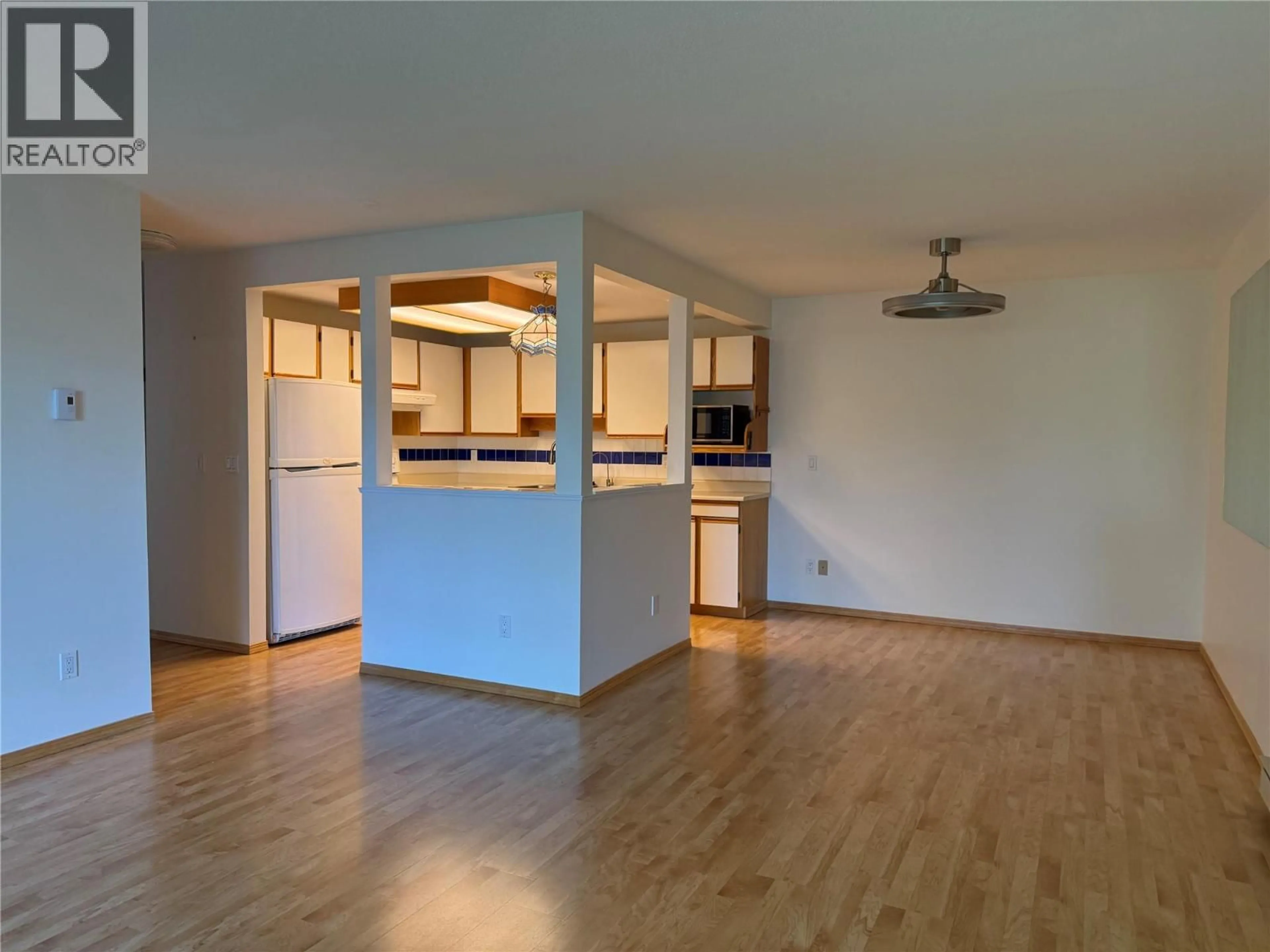 Open concept kitchen, wood/laminate floor for 208 - 255 MCINTOSH ROAD, Kelowna British Columbia V1X2C5